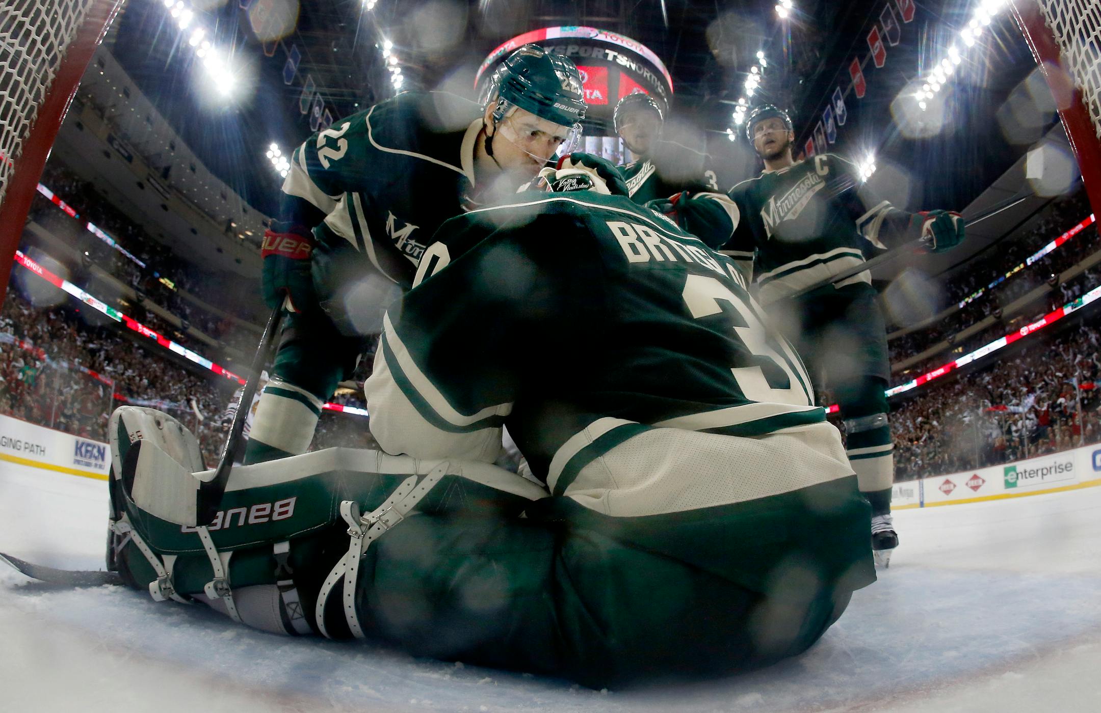 Nino Niederreiter (22) congratulated Wild goalie Ilya Bryzgalov (30) after he made a save on a shot by Jeremy Morin.
