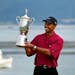 Tiger Woods holds the trophy after capturing the 100th U.S. Open at Pebble Beach in June of 2000