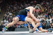 Hastings' Blake Beissel, going low against Cambridge-Isanti's Leo Edblad during the state tournament last season, is 38-1 at 121 pounds.