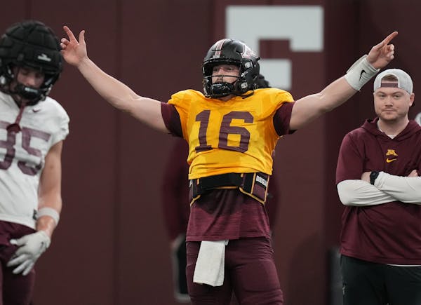 Gophers quarterback Max Brosmer, a transfer from New Hampshire, directs players during practice Thursday.