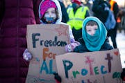 Finnea Vanderford, left, 6, of Minneapolis and her brother Connor, 4, held signs during a rally and protest march on Inauguration Day. ] LEILA NAVIDI 