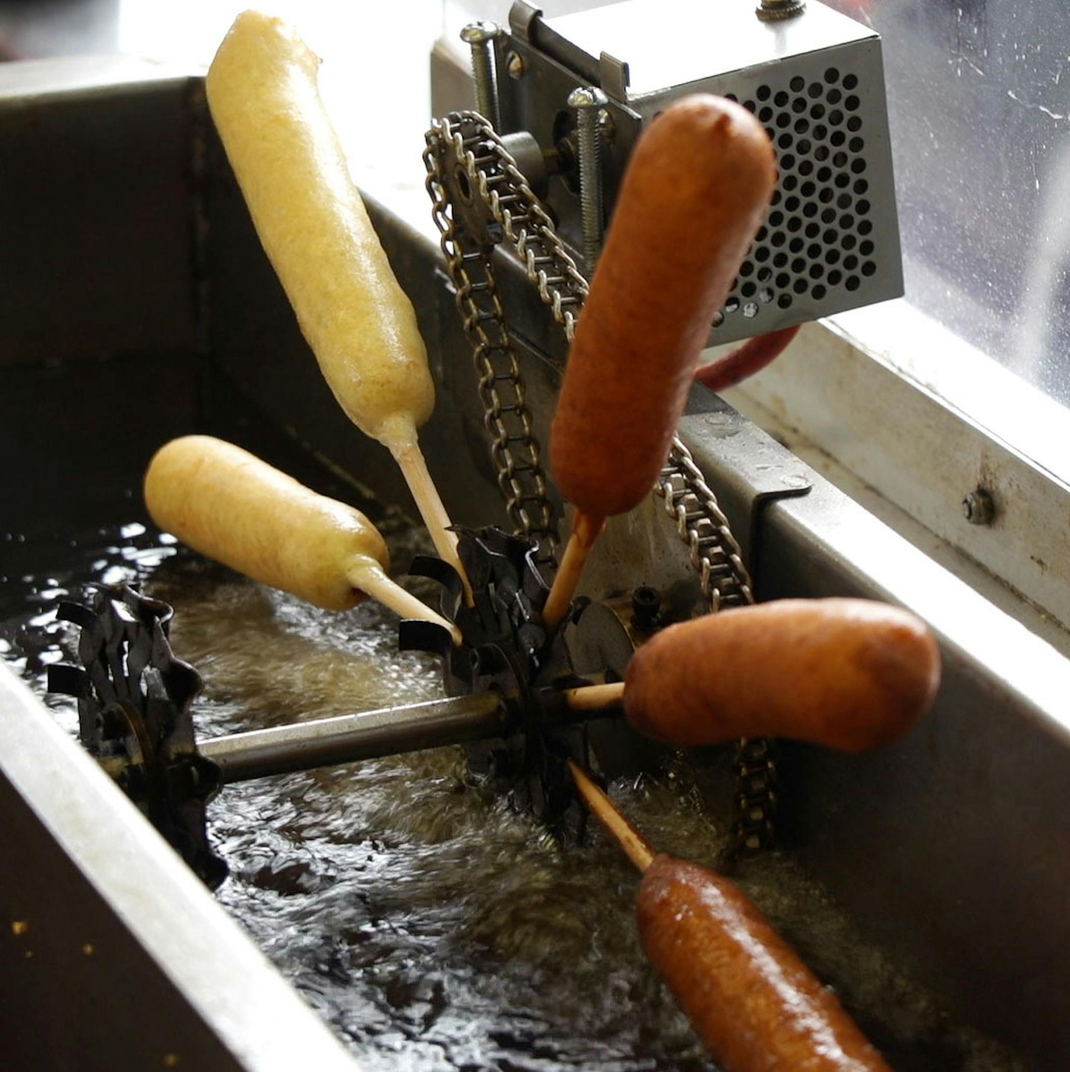 Battered Pronto Pups ride a wheel though a vat of soy oil before being plucked for hungry customers. ] MARK VANCLEAVE ï mark.vancleave@startribune.com * Pronto Pups have been a Minnesota State Fair staple since 1947. Photographed Thursday, Aug. 24, 2017.