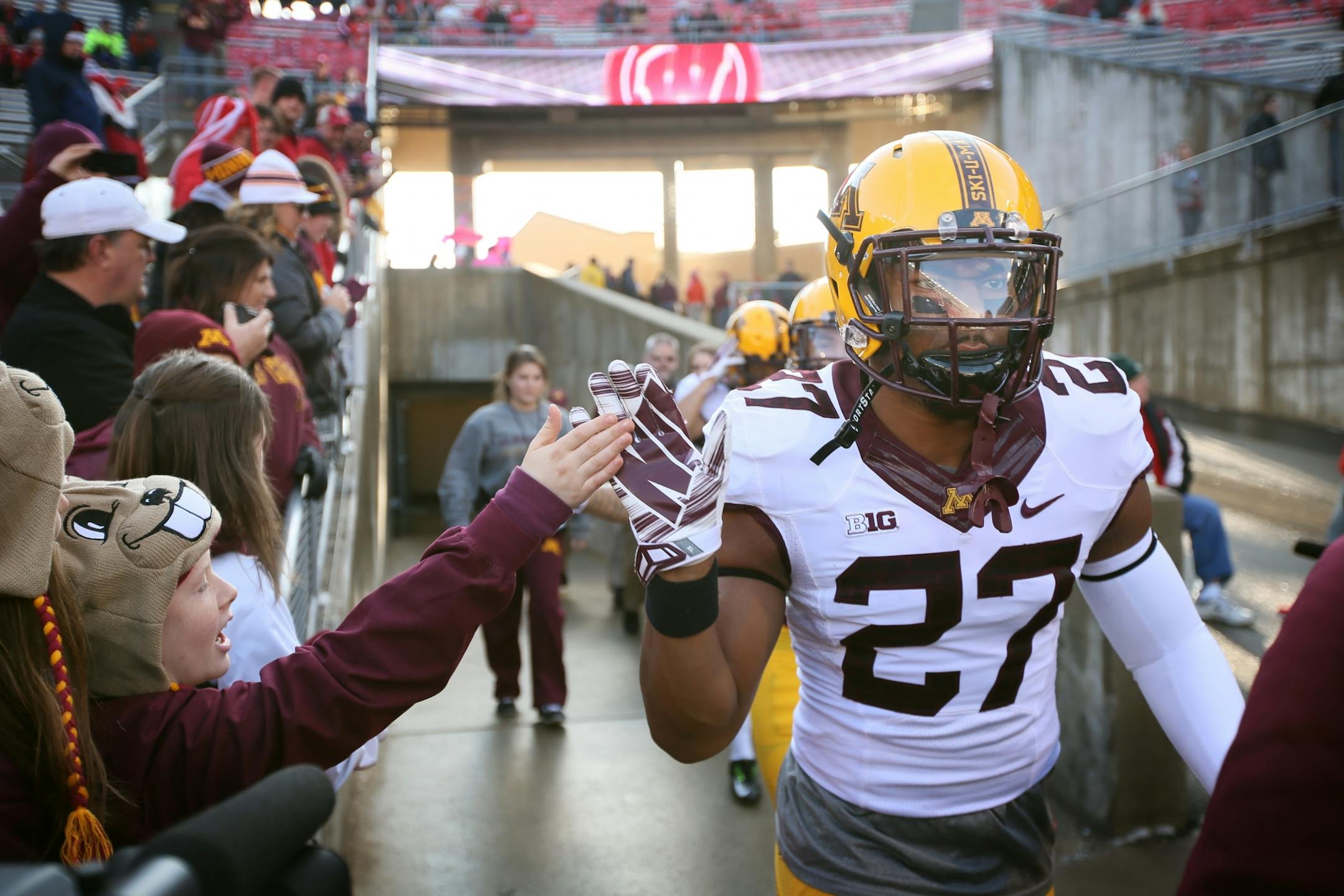 Minnesota Golden Gophers running back David Cobb (27) shook hands with fan Cormac O'Neill during pregame wamups Saturday November 29, 2014 in Madison, Wisconsin.