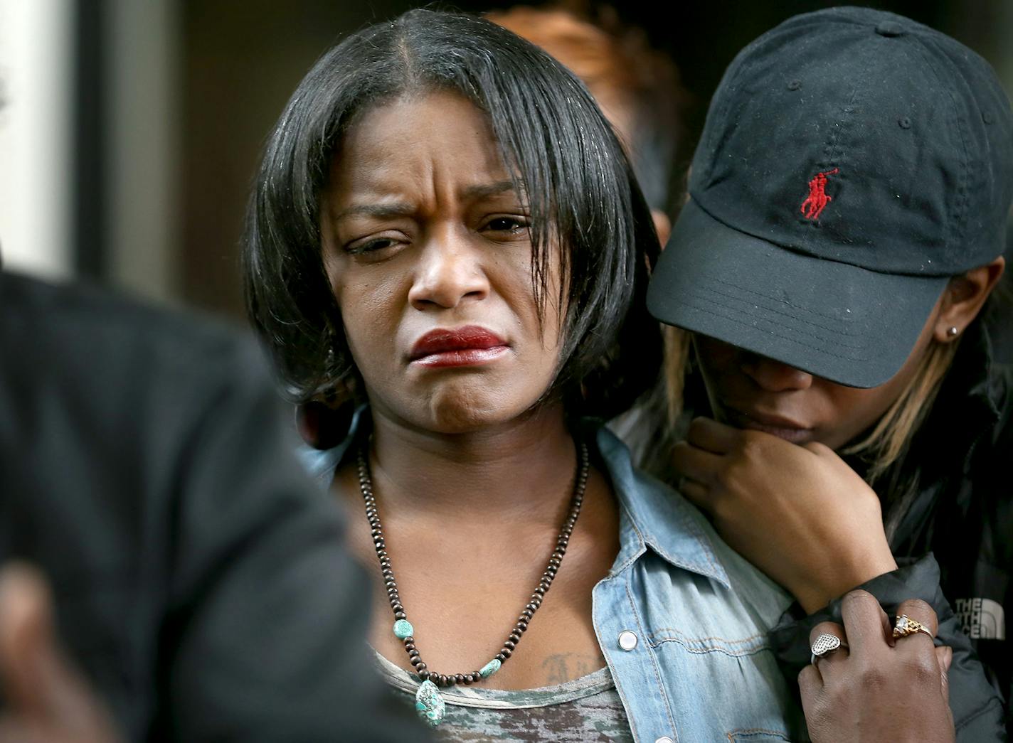 RayAnn Hayes, the woman who had been previously referred to as the girlfriend of Jamar Clark by Hennepin County Attorney Mike Freeman, is consoled by others during a press conference, Monday, April 4, 2016 at the Hennepin County Government Center.