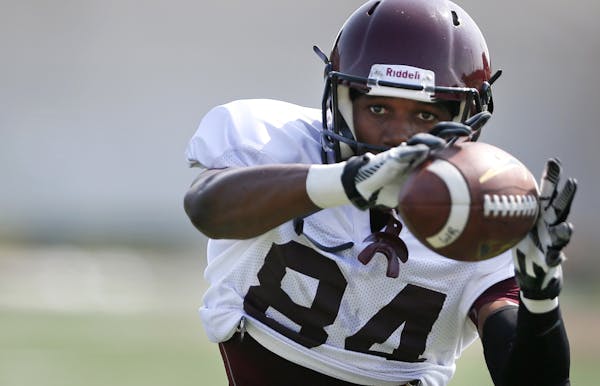 Isaiah Gentry catches a pass during Gopher football practice at the University of Minnesota Sunday August 3 , 2014 in Minneapolis , MN . ] Jerry Holt 