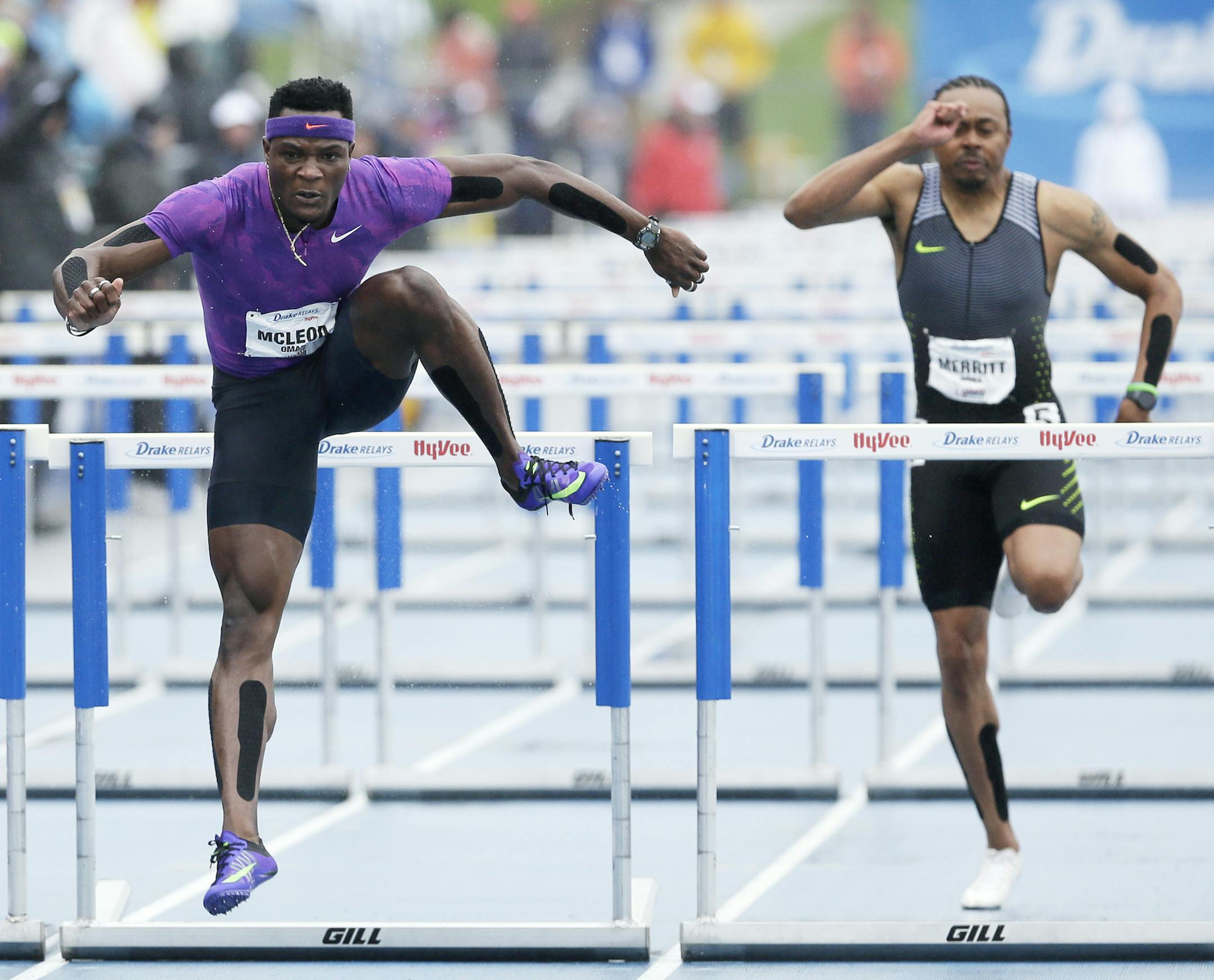 Omar McLeod, center, clears the final hurdle as he wins the men's special 110-meter hurdles at the Drake Relays athletics meet, Saturday, April 30, 2016, in Des Moines, Iowa. (AP Photo/Charlie Neibergall)
