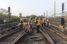 FILE - In this May 27, 2015 file photo provided by the Metropolitan Transit Authority, workers repair a section of cable that was severed by vandals w