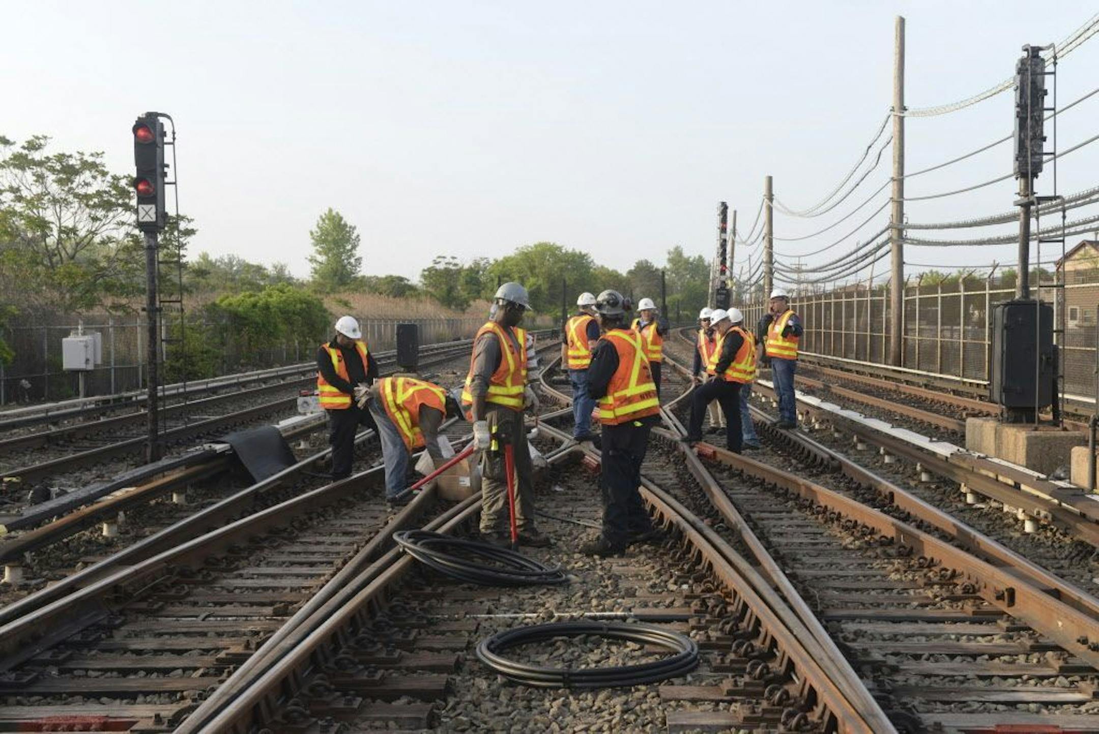 FILE - In this May 27, 2015 file photo provided by the Metropolitan Transit Authority, workers repair a section of cable that was severed by vandals who stole 500 feet of copper cable from train tracks along the A train subway line south of Howard Beach, in the Queens borough of New York. The crime forced the MTA to suspend train service entirely in the area and replace it with shuttle buses. The theft that shut down the subway�s biggest line and snarled the commute for 100,000 people is only th