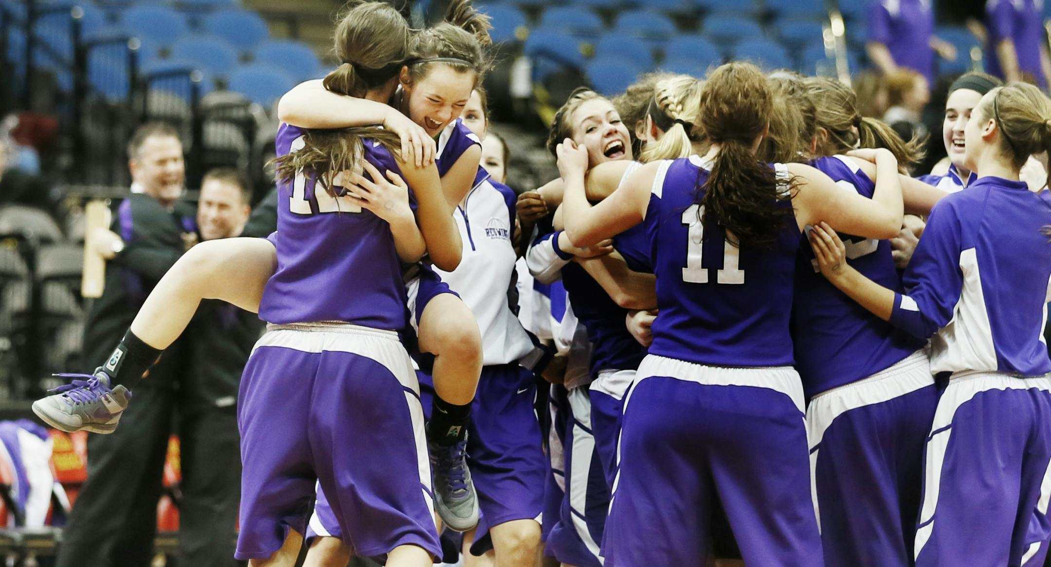 Tesha Buck (12) and teammate McKayla Muelken celebrated their 61- 59 win over Richfield.