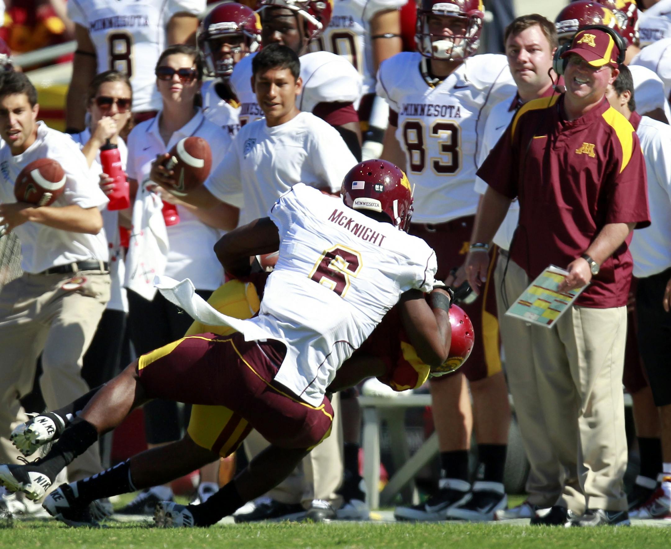 Minnesota head coach Jerry Kill and the bench could only watch as Torin Harris (4) intercepted a pass intended for Da'Jon McKnight (6) late in the fourth quarter.