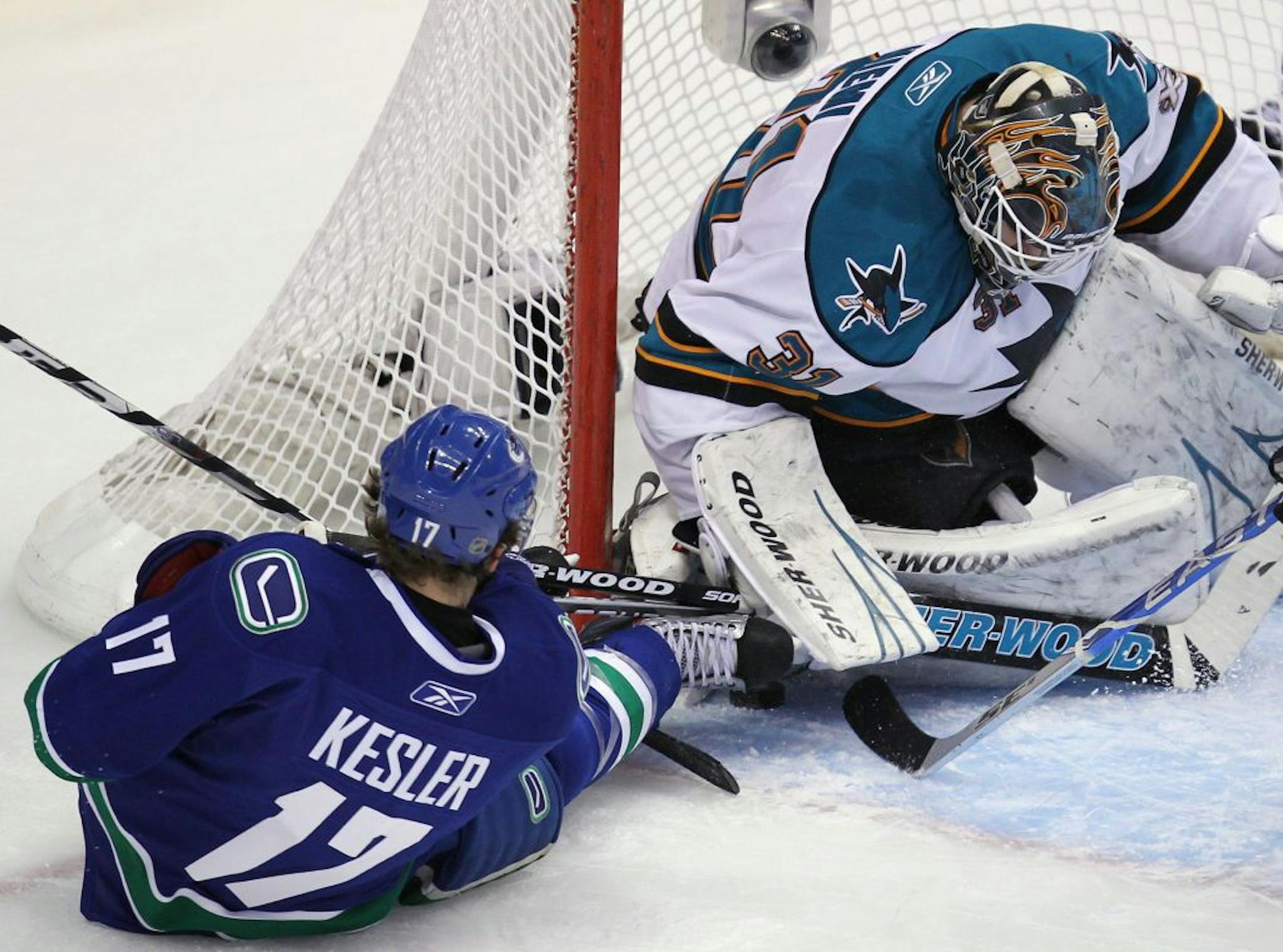 Vancouver Canucks' Ryan Kesler, left, tries to shoot against San Jose Sharks goaltender Antti Niemi, of Finland, during the first period of Game 5 of NHL hockey Stanley Cup playoffs Western Conference finals Tuesday, May 24, 2011, in Vancouver, British Columbia.