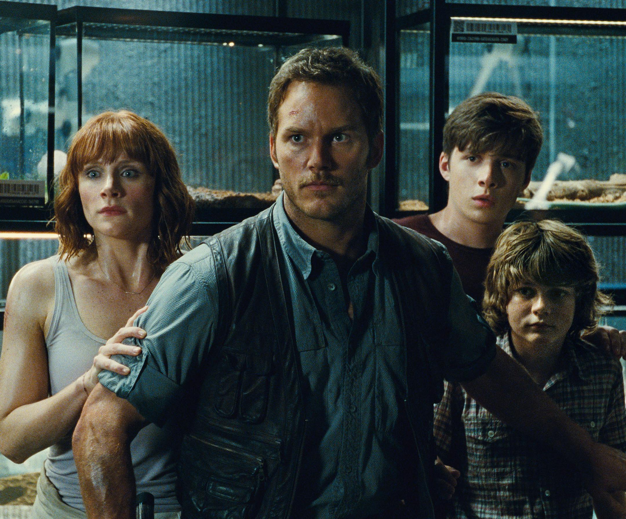 This photo provided by Universal Pictures shows, Bryce Dallas Howard, from left, as Claire, Chris Pratt as Owen, Nick Robinson as Zach, and Ty Simpkins as Gray, in a scene from the film, "Jurassic World," directed by Colin Trevorrow, in the next installment of Steven Spielberg's groundbreaking "Jurassic Park" series. The Universal Pictures 3D movie releases in theaters on June 12, 2015. (Universal Pictures/Amblin Entertainment via AP)
