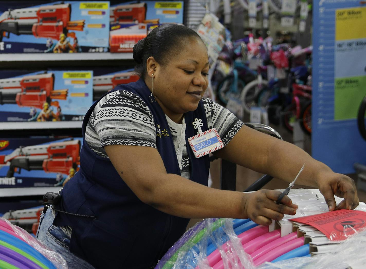 Balo Balogun labels items in preparation for a holiday sale at a Walmart Supercenter, Wednesday, Nov. 27, 2019, in Las Vegas. Black Friday once again kicks off the start of the holiday shopping season. But it will be the shortest season since 2013 because of Thanksgiving falling on the fourth Thursday in November, the latest possible date it can be. (AP Photo/John Locher)