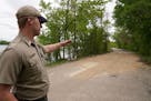 Assistant park manager Nick Bartels pointed to an area of the main road leading into Fort Snelling State Park that had been temporarily repaired in Ma