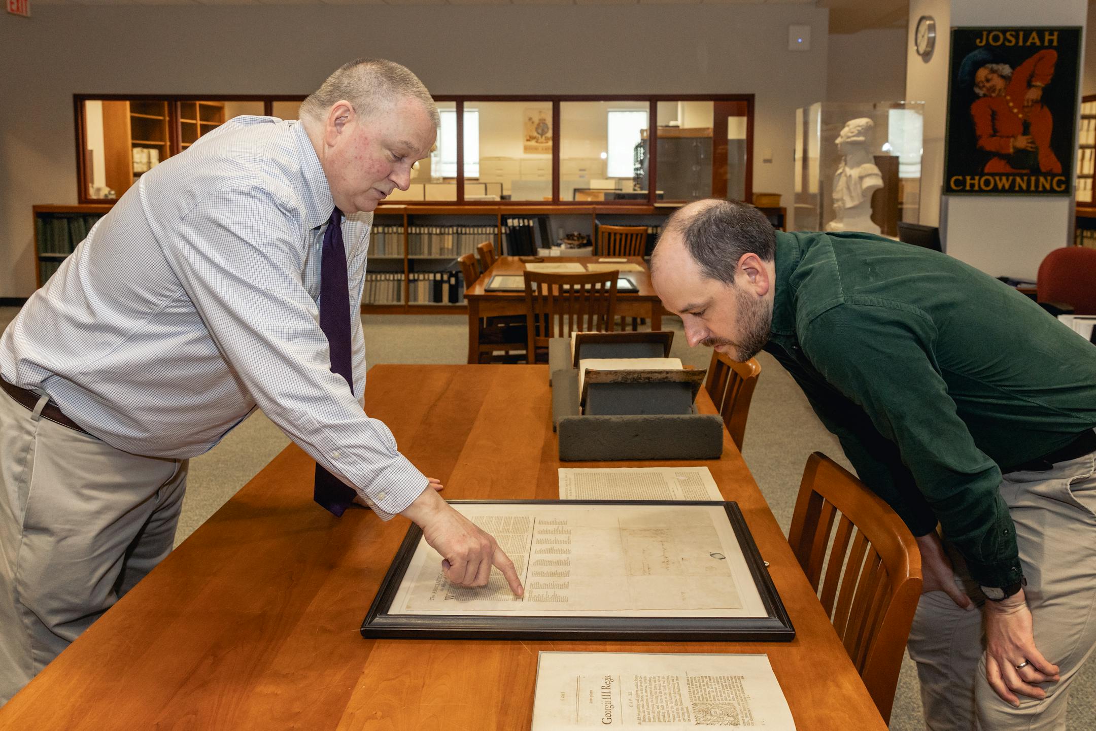 David Schmidt visits Special Collections at the John D.
Rockefeller Jr. Library on May 11, 2023, to capture video for a
documentary on the American Revolution. Pictured: Associate
Librarian Doug Mayo (left) shows director David Schmidt (right)
collections materials relating to the American Revolution.
