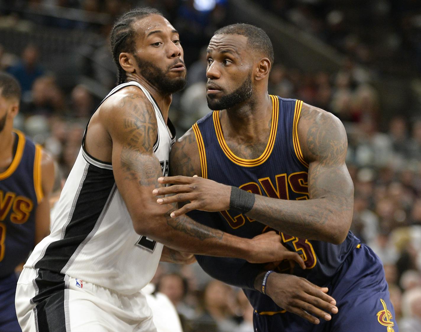 San Antonio Spurs forward Kawhi Leonard, left, guards Cleveland Cavaliers forward LeBron James during the first half of an NBA basketball game, Monday, March 27, 2017, in San Antonio. (AP Photo/Darren Abate)