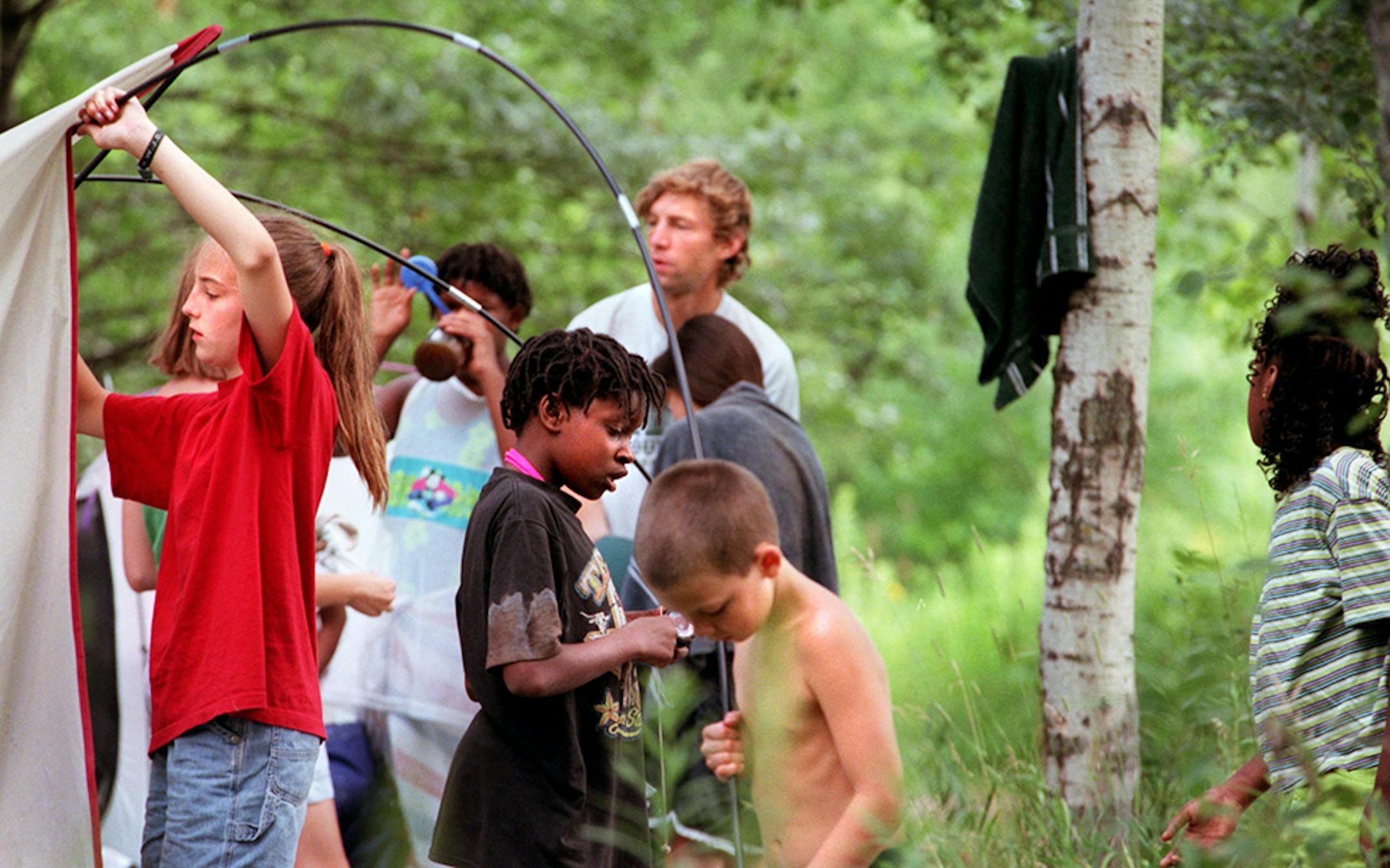 Campers work on taking down the tents after their overnight stay in Afton State Park so that the next camper would find it a clean camp site.