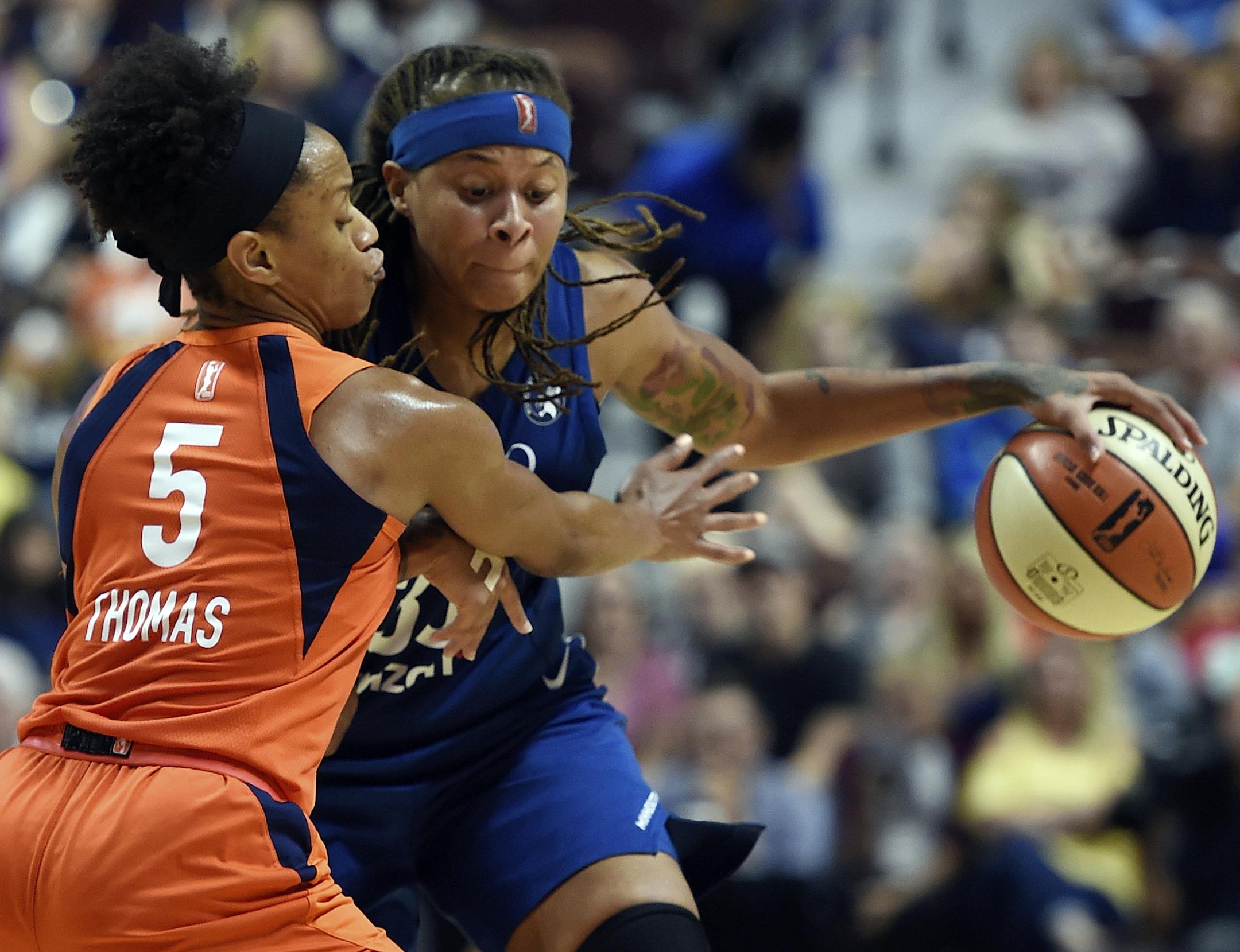 Minnesota Lynx forward Seimone Augustus drives past Connecticut Sun guard Jasmine Thomas during the second half of a WNBA basketball game Friday, Aug. 17, 2018, in Uncasville, Conn. (Sean D. Elliot/The Day via AP)
