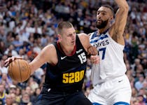 Nikola Jokic (15) of the Nuggets is defended by Rudy Gobert (27) of the Timberwolves in the second quarter at Ball Arena in Denver on Tuesday.