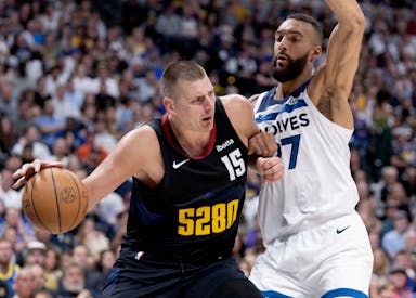 Nikola Jokic of the Nuggets is defended by Rudy Gobert of the Timberwolves in Game 5 of the series at Ball Arena in Denver on Tuesday night.
