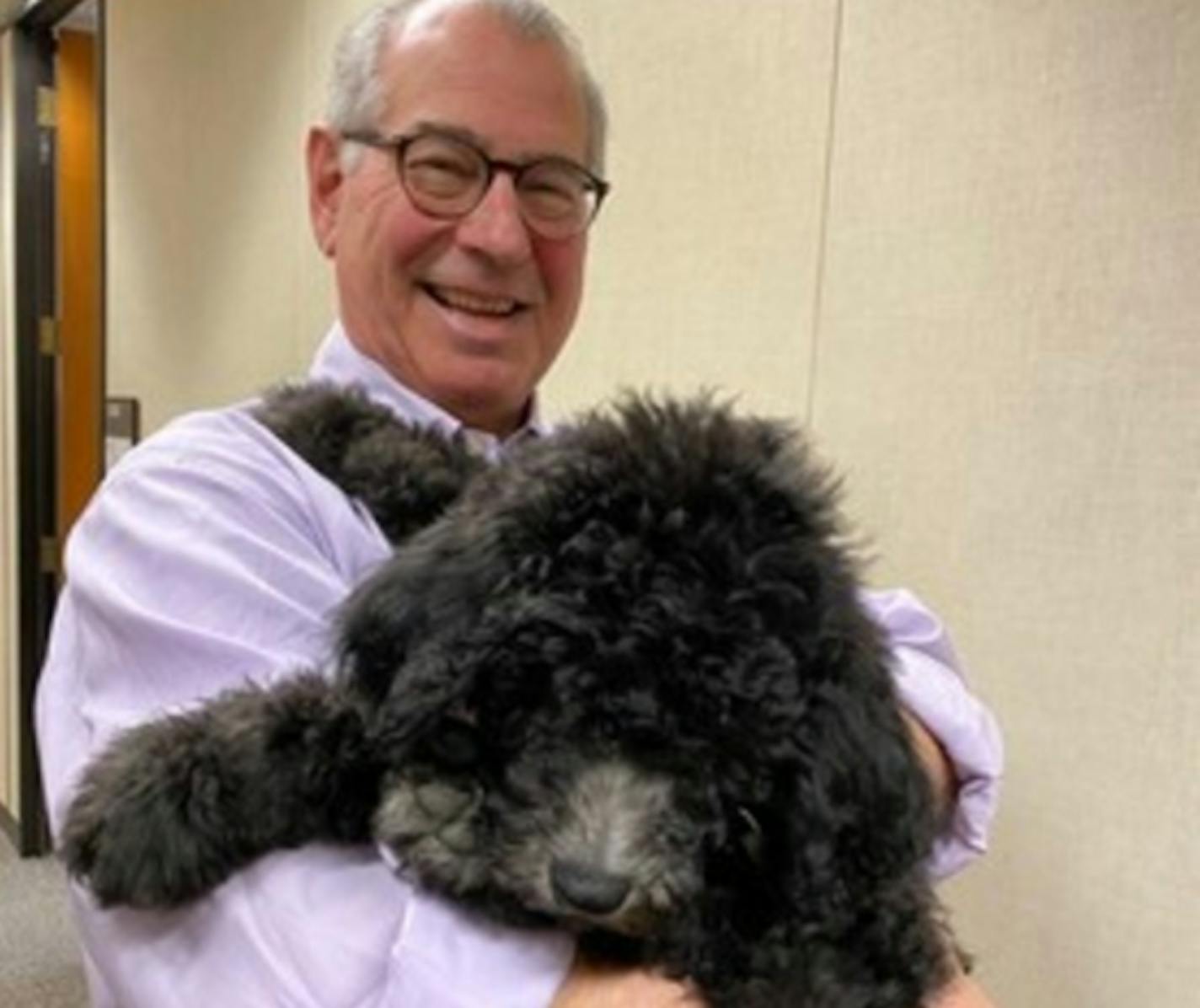 Hennepin County Attorney Mike Freeman with the office's first emotional support animal, Barrett, a golden doodle.