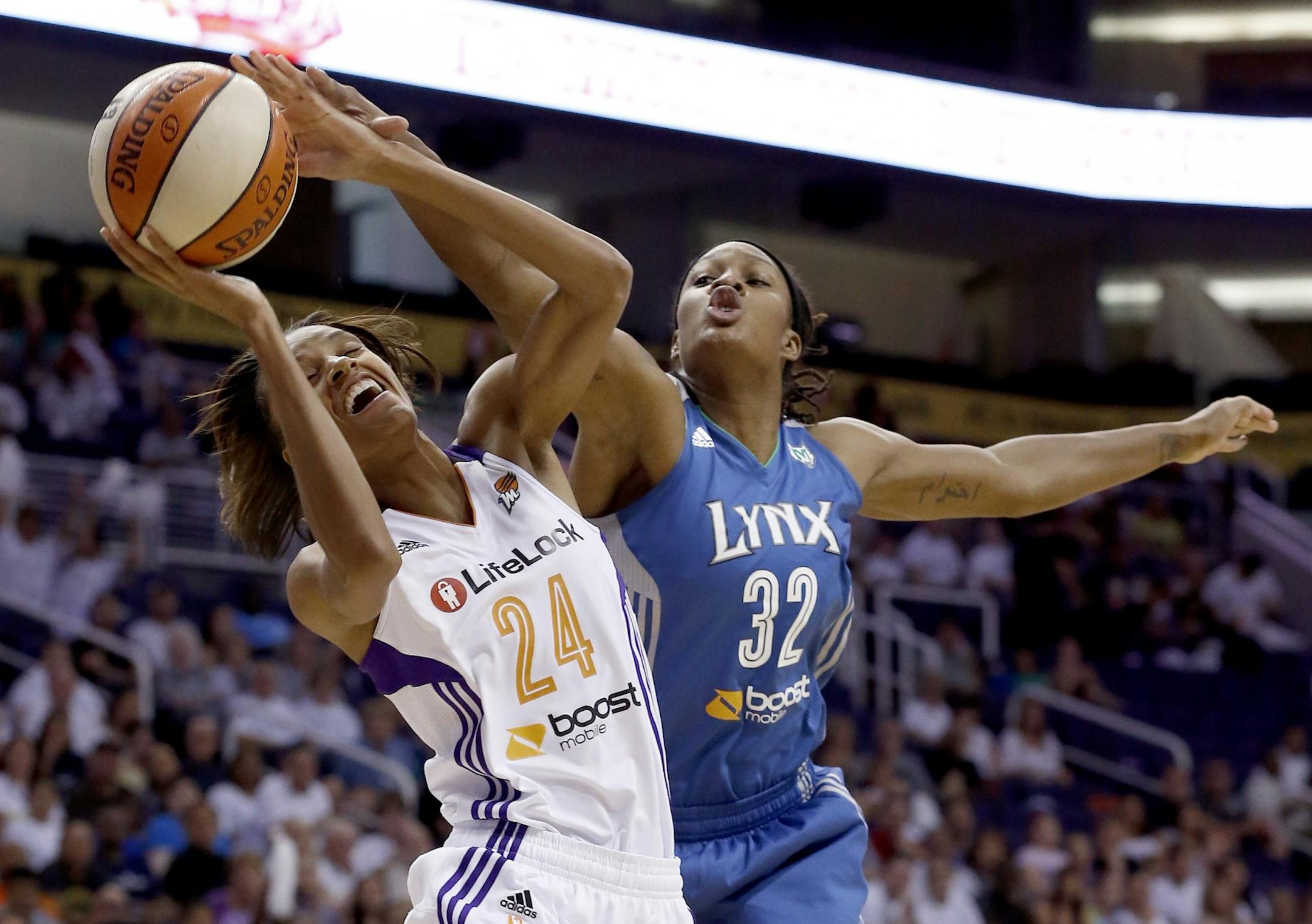Phoenix Mercury's DeWanna Bonner (24) tries to shoot as Minnesota Lynx's Rebekkah Brunson (32) defends during the first half of a WNBA Western Conference Finals basketball game on Sunday, Sept. 29, 2013, in Phoenix.