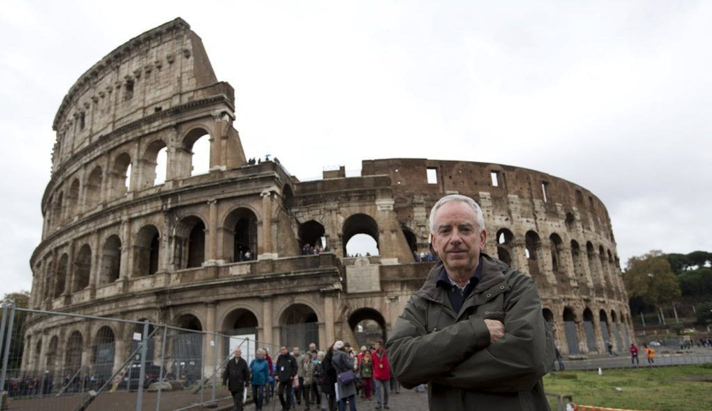 Archaeologist Daniele Manacorda poses in front of Rome's Colosseum Friday Nov.7, 2014.