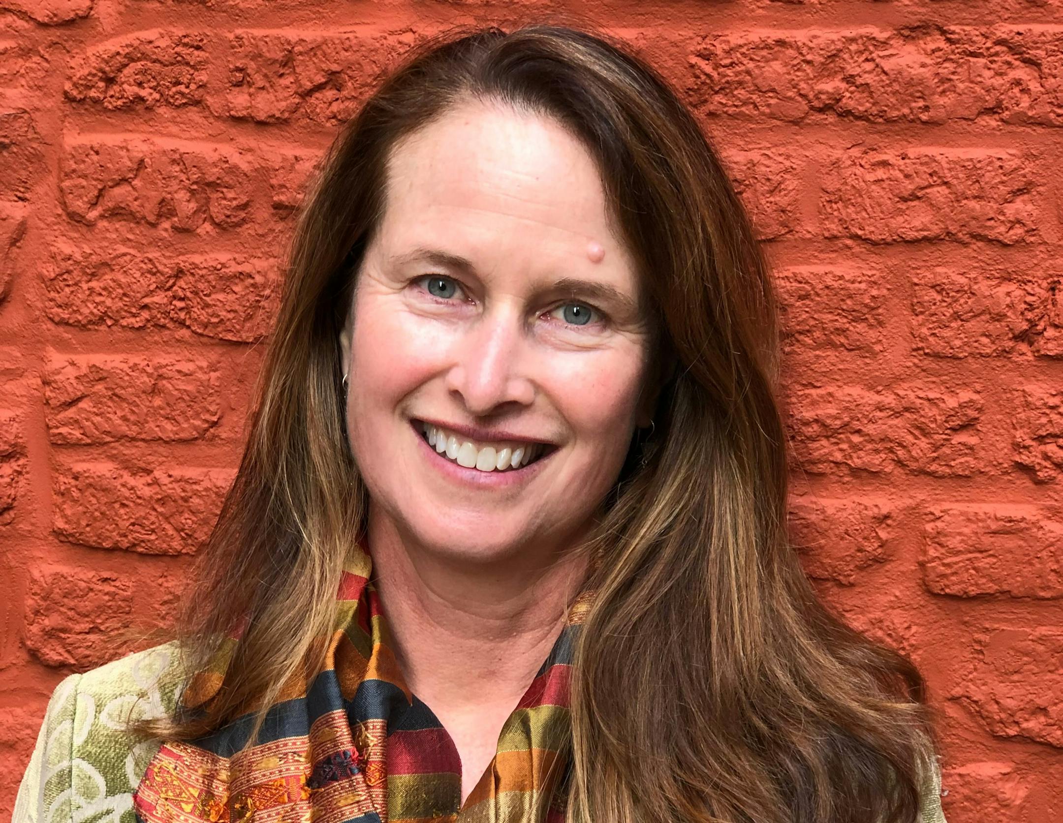 photo of author Janet Rich Edwards in front of brick wall