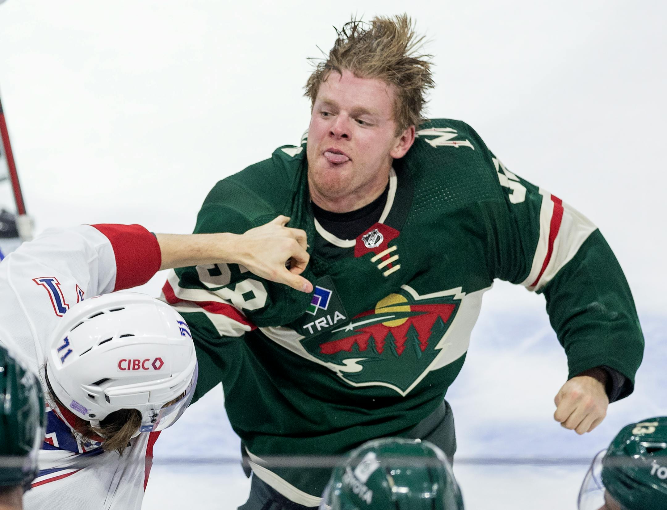 Jake Evans (71) of the Montreal Canadiens and Mason Shaw (58) of the Minnesota Wild fight in the third period.