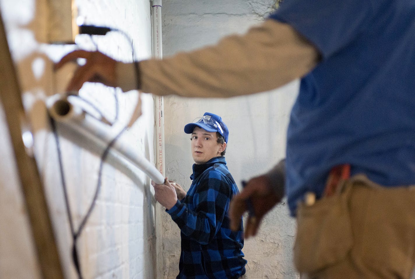 Drew Gardner of Drew Gardner Concrete and Waterproofing and Alejandro Aguilar level the pipe that leads to the sump basin.] BRIDGET BENNETT SPECIAL TO THE STAR TRIBUNE &#x2022; bridget.bennett@startibune.com Thursday, April 2, 2015 at a home in the Seward neighborhood of Minneapolis, MN. They are installing a sump pump in the basement of the home. The sump basin is where the water is collected. It is then pumped out though the pvc pipe, to outside. The whole system is a "sump pump."