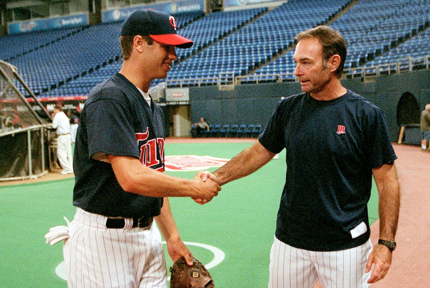 Twins press conference to announce the signing of No. 1 overall draft pick Joe Mauer, a Cretin-Derham Hall grad who will head to the club's Elizabethtown Rookie League 
IN THIS PHOTO: Twins 1st round draft pick Joe Mauer, a Cretin-Derham Hall grad shakes hands with another Paul Molitor after batting practice at the Metrodome in Minneapolis on Wednesday after signing a contract with the Twins. Mauer, will head to the club's Elizabethtown Rookie League in Tennessee.