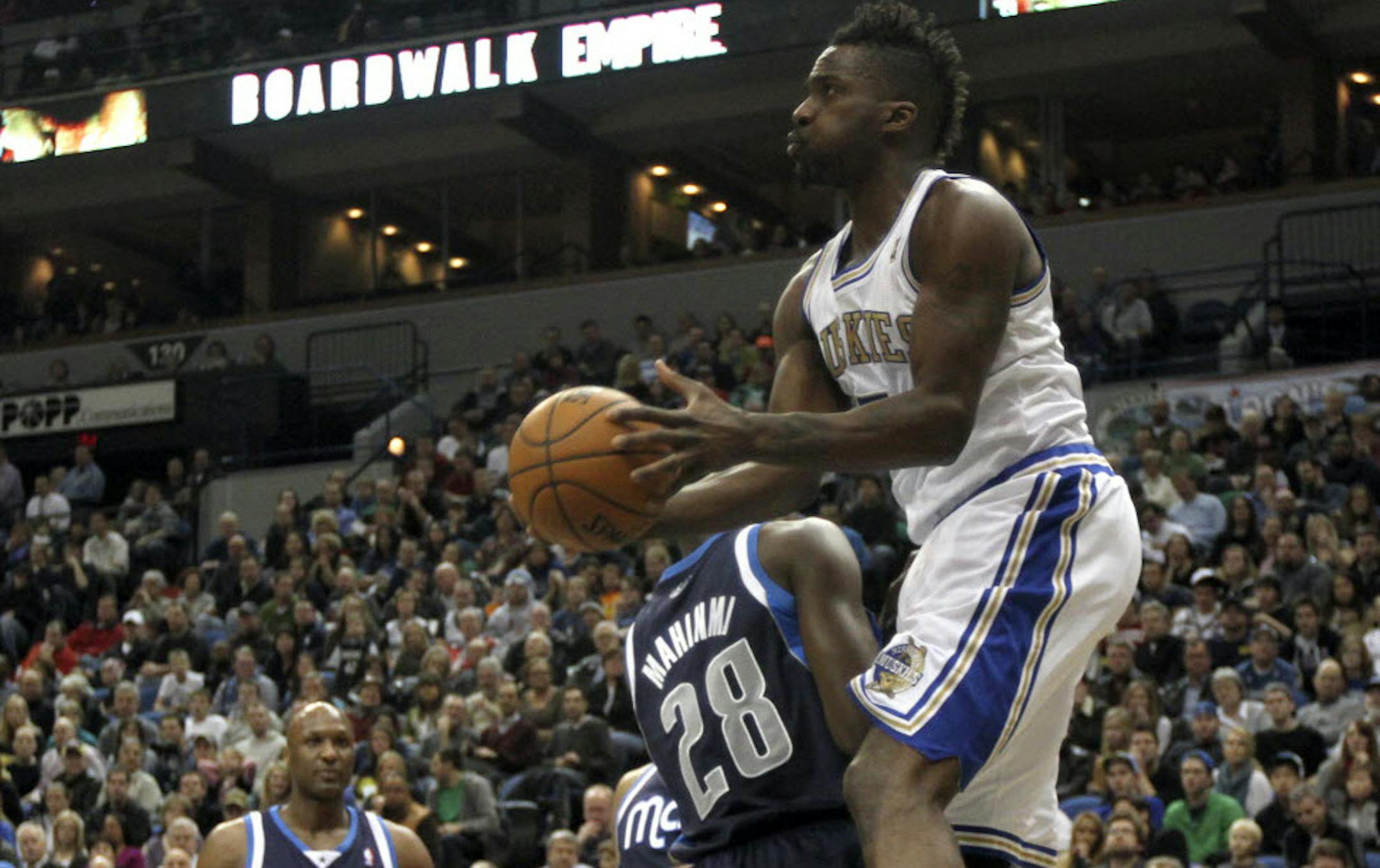 Martell Webster shoots around Dallas' Ian Mahinmi.