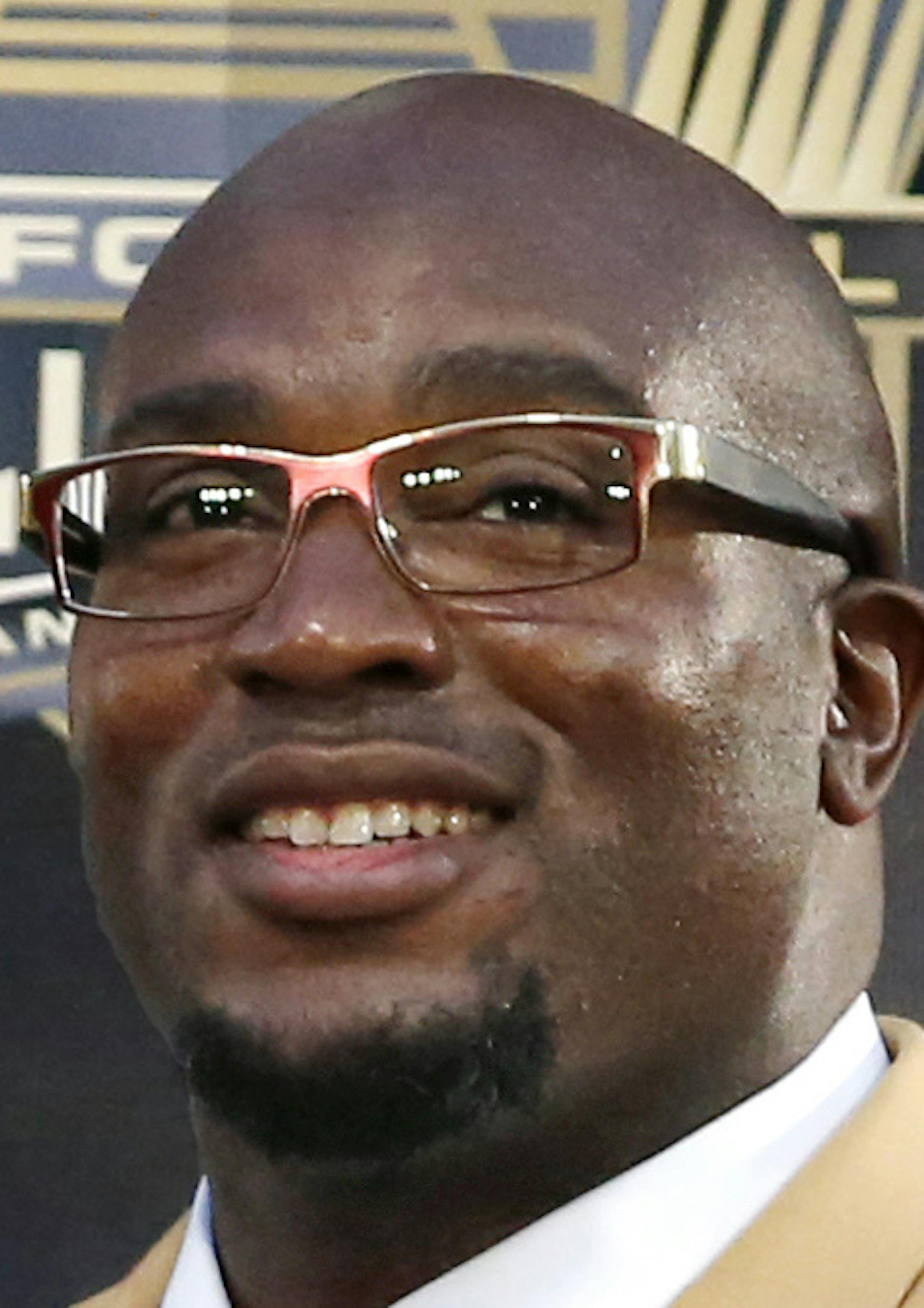 Former NFL player Will Shields poses with his bust during inductions at the Pro Football Hall of Fame on Saturday, Aug. 8, 2015, in Canton, Ohio. (AP Photo/Gene J. Puskar)