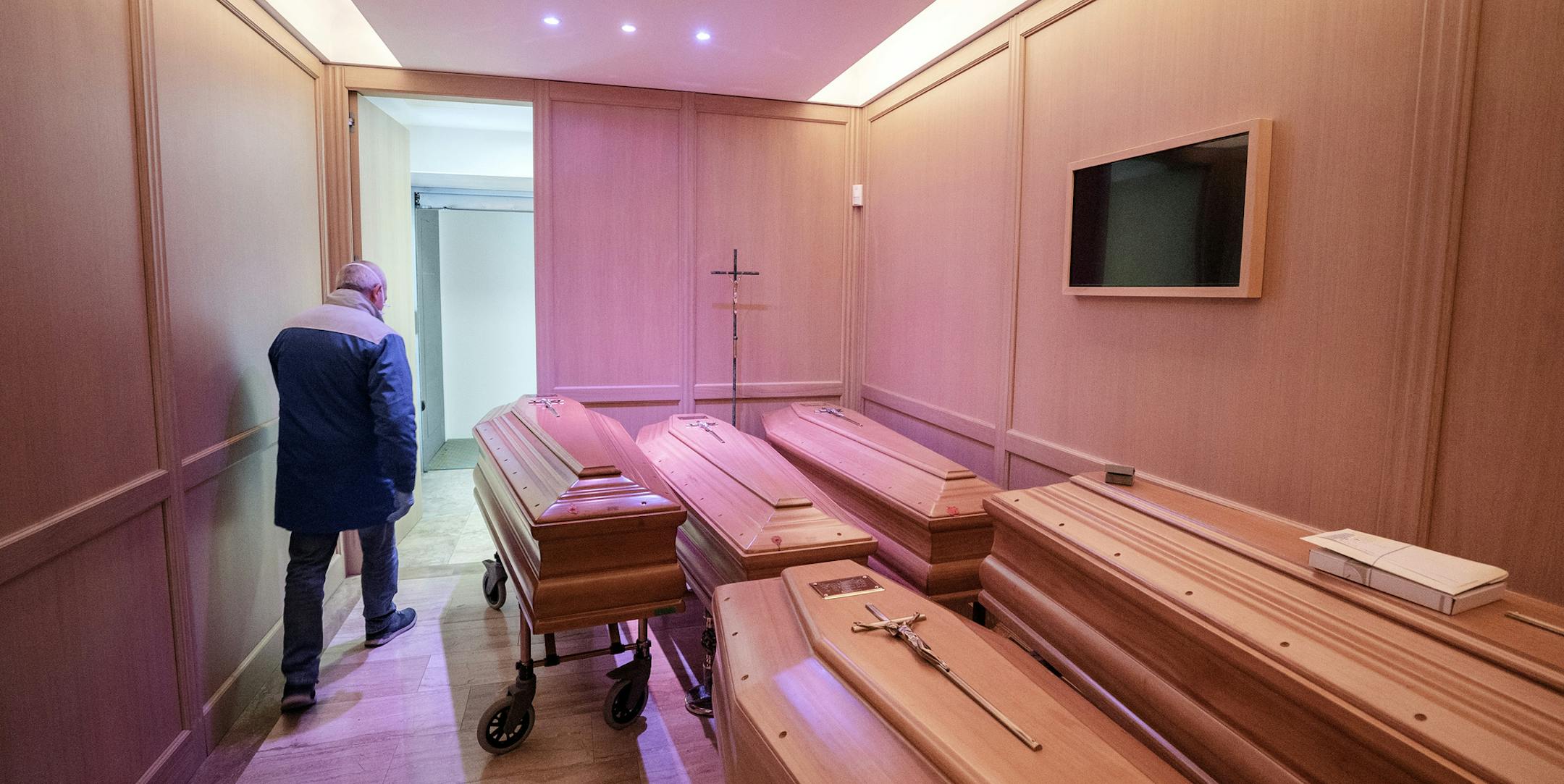 FILE - A funeral home in Piacenza, Italy, is full of coffins, March 25, 2020, due to the high number of deaths from the coronavirus. As the infection curve in Italy flattens and the government moves gingerly toward reopening the country, more Italians, fueled by growing anger over thousands of deaths and what they see as health officialsÕ failures in handing the crisis, are seeking to hold someone accountable. (Alessandro Grassani/The New York Times)