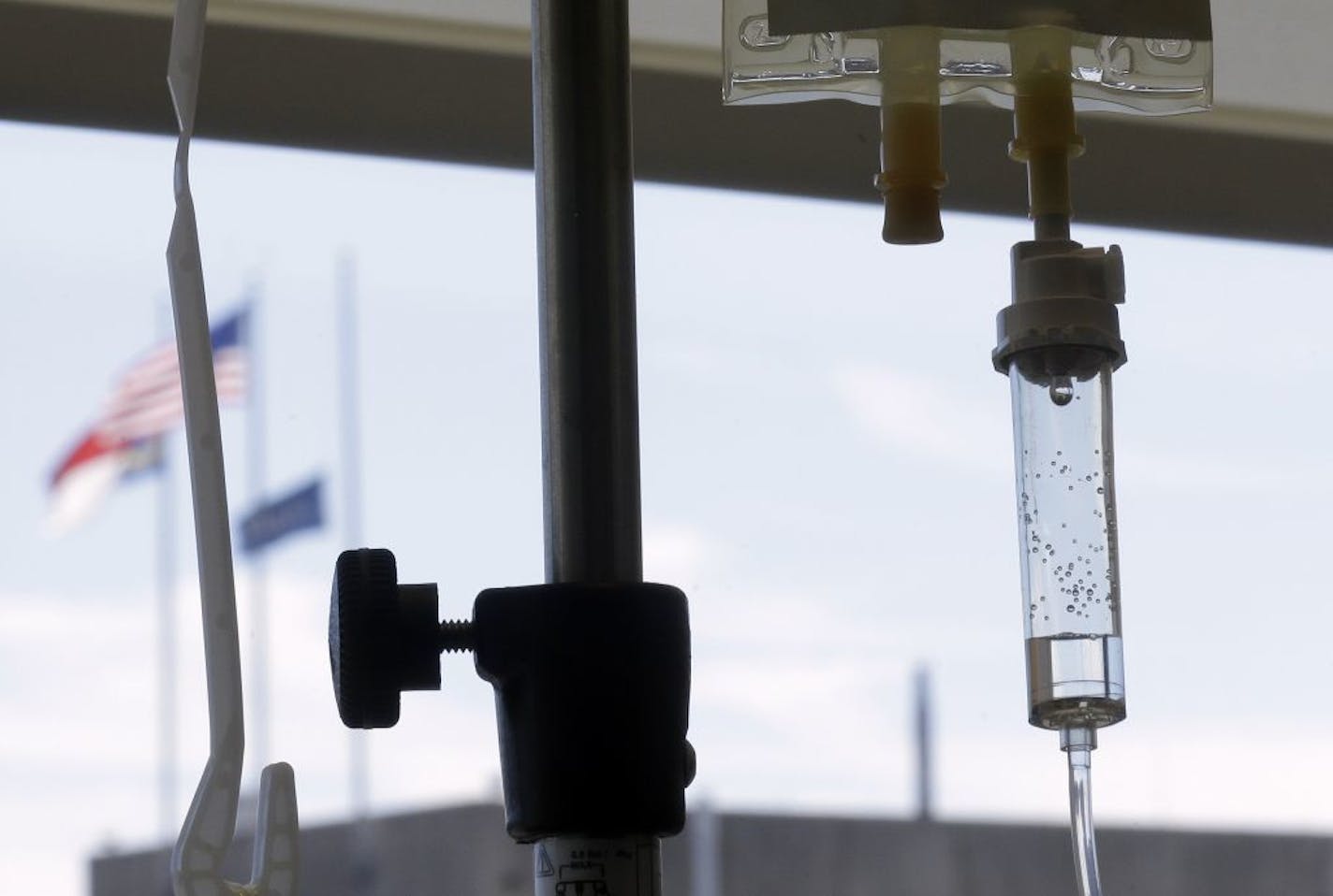 FILE - In this Sept. 5, 2013 file photo, chemotherapy is administered to a cancer patient via intravenous drip at a hospital in Durham, N.C. According to a study released on Wednesday, May 17, 2017, most doctors did not discuss the cost of cancer treatment with patients, spent less than two minutes on it when they did, and usually did so only after patients brought it up.