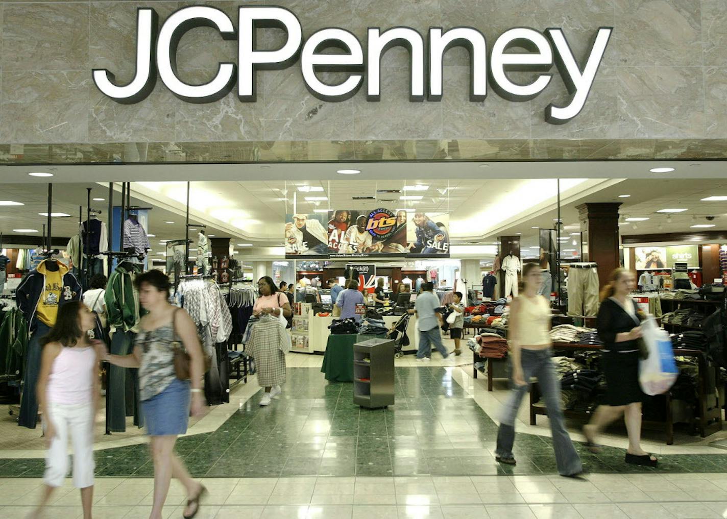 FILE - In this Aug. 16, 2005 file photo, customers walk out of a J.C. Penny department store in Dallas. J.C. Penney said Friday, Feb. 24, 2017, that it will be closing anywhere from 130 to 140 stores as well as two distribution centers over the next several months as it aims to improve profitability in the era of online shopping.(AP Photo/Matt Slocum)