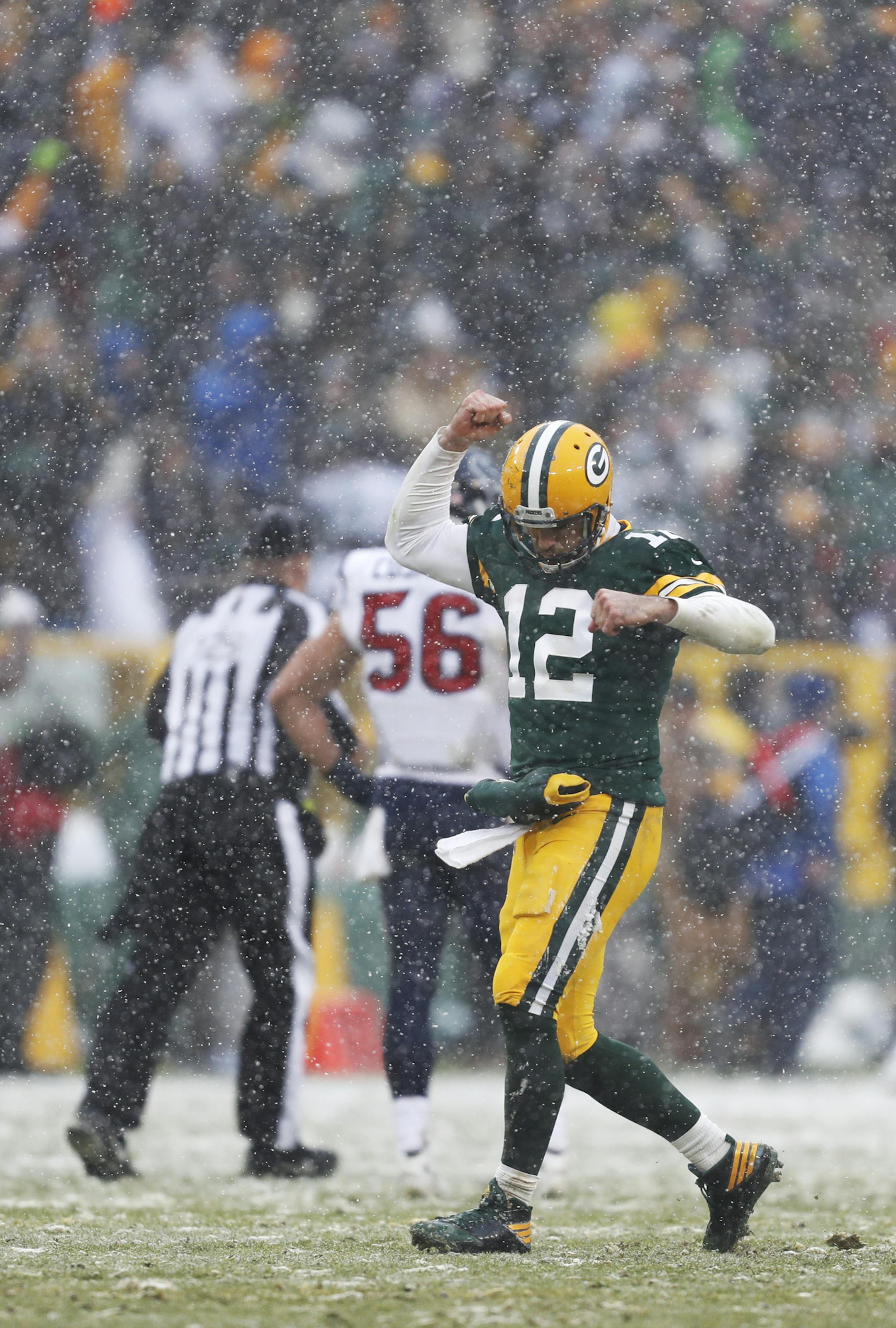 Green Bay Packers quarterback Aaron Rodgers reacts after throwing a touchdown pass to Jordy Nelson during the second half of an NFL football game against the Houston Texans Sunday, Dec. 4, 2016, in Green Bay, Wis. (AP Photo/Matt Ludtke)