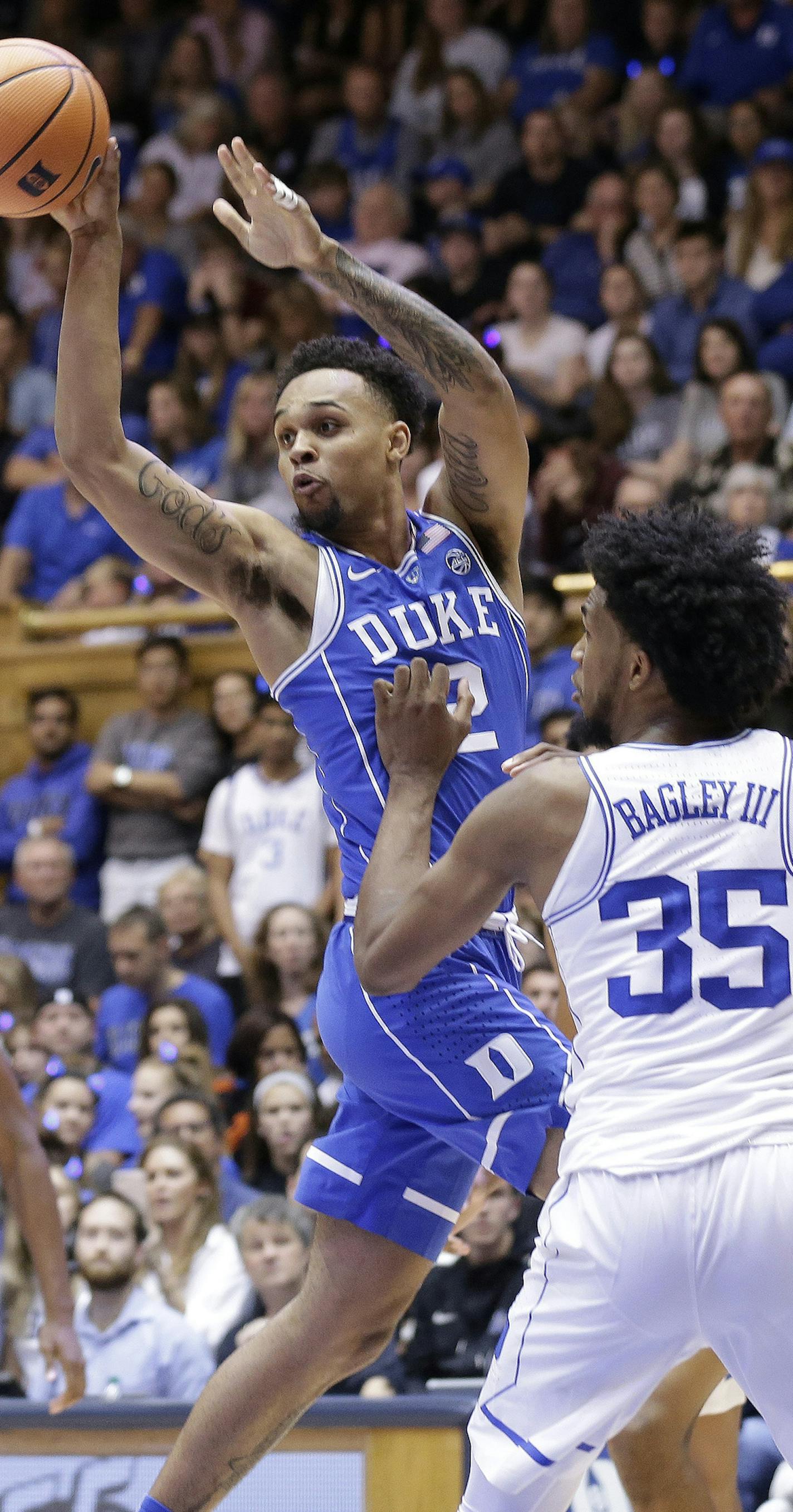 Duke's Gary Trent Jr. (2) passes around Marvin Bagley III (35) in the Blue-White scrimmage during the NCAA college basketball team's Countdown to Craziness event to kick off the season in Durham, N.C., Friday, Oct. 20, 2017. (AP Photo/Gerry Broome) ORG XMIT: NCGB112