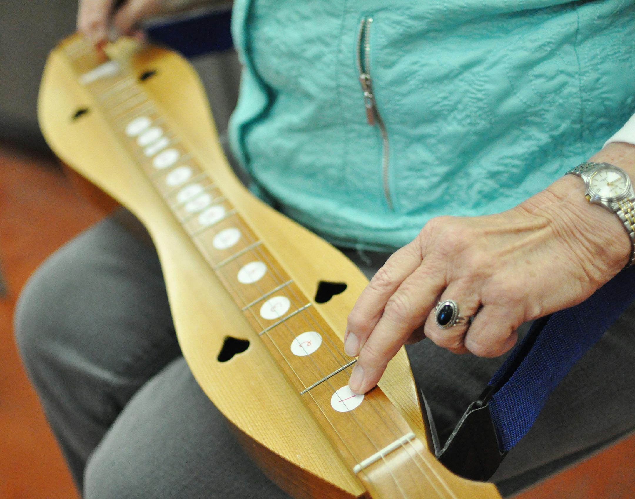 New players often mark the dulcimer with stickers to correspond with the numbering in the songbook. Liz Rolfsmeier, Special to the Star Tribune