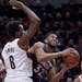 Minnesota Timberwolves center Karl-Anthony Towns, right, drives to the basket past Portland Trail Blazers forward Al-Farouq Aminu during the first hal
