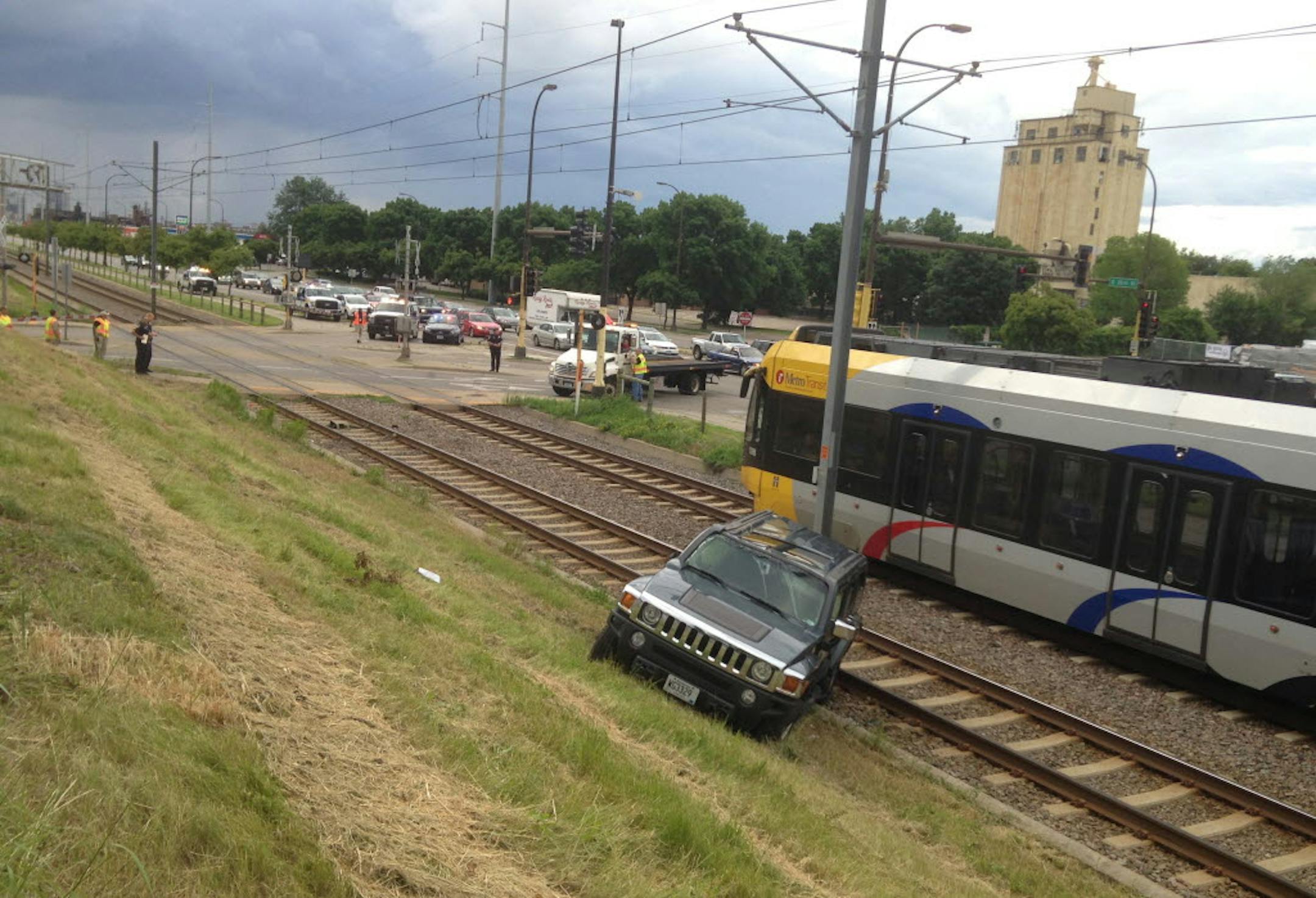 Traffic was backed up and southbound light rail was halted after a car crashed and landed across the southbound light rail tracks at 35th St and Hiawatha Friday night.