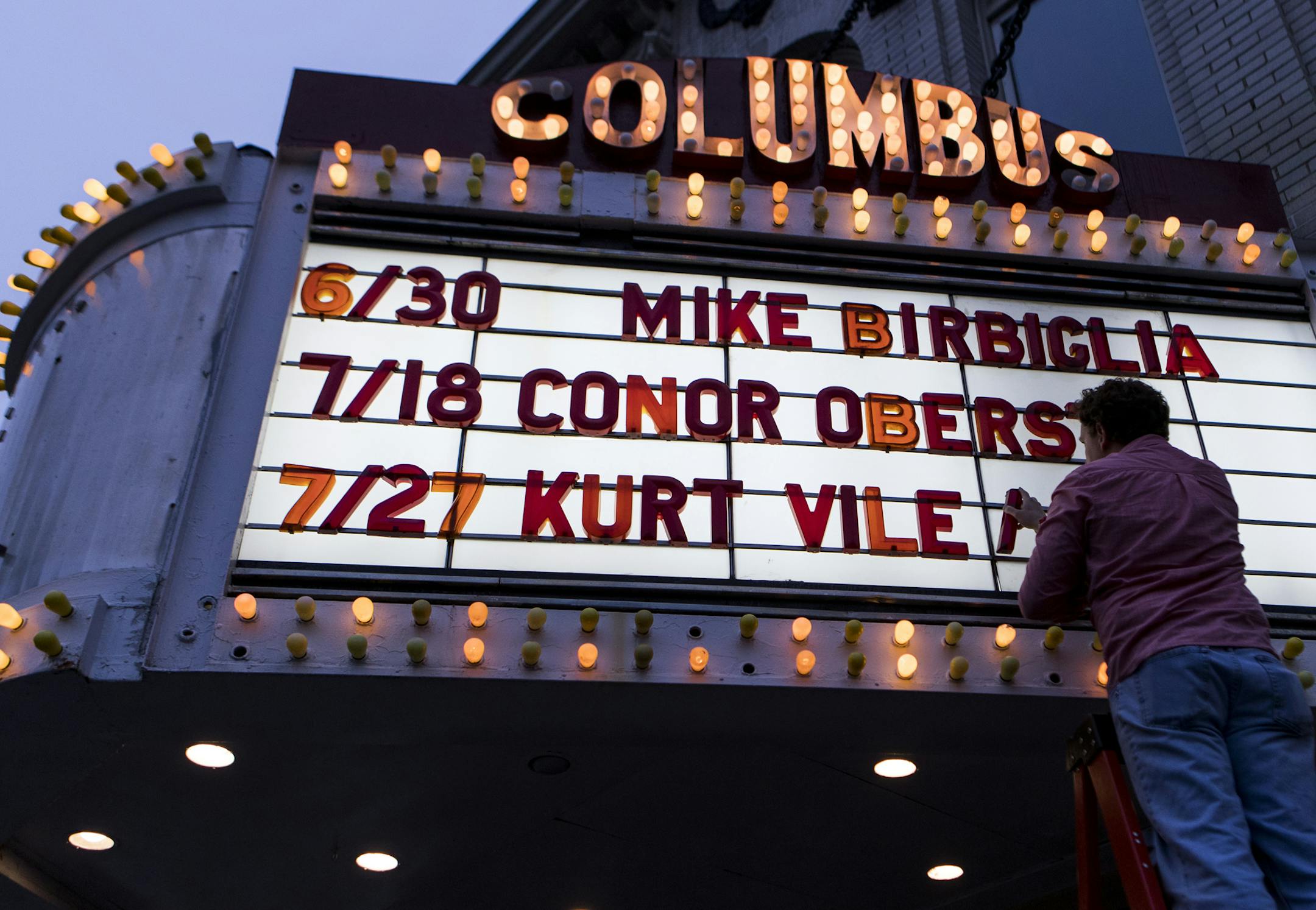 Shawn Schillberg, head of marketing and operations, changes the marquee at the Columbus Theatre in Providence, Rhode Island, on May 3, 2019. MUST CREDIT: Photo for The Washington Post by Ruby Wallau