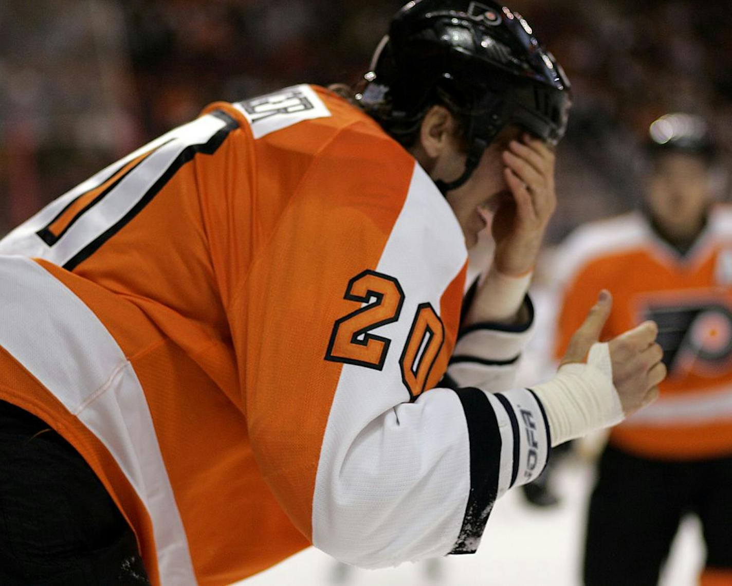 Philadelphia Flyers captain Chris Pronger puts his hand over his eyes as he heads for the locker room after being struck in the face with a stick during the first period of an NHL hockey game with the Toronto Maple Leafs, Monday, Oct. 24, 2011, in Philadelphia.