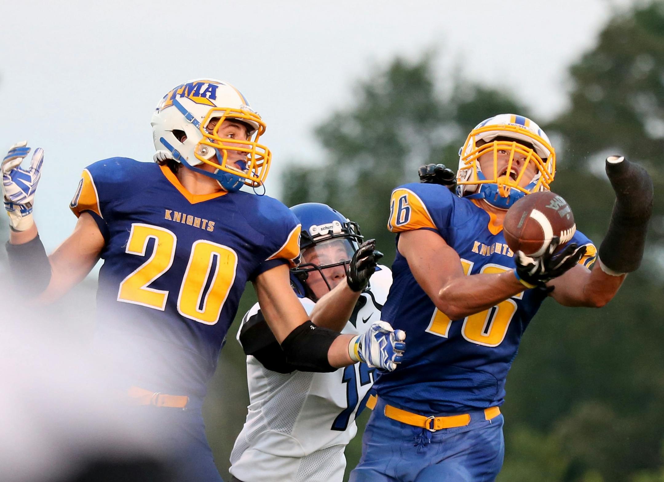 St. Michael-Albertville's Will Berning made the interception basically one-handed during the first half. ] (KYNDELL HARKNESS/STAR TRIBUNE) kyndell.harkness@startribune.com St. Micheal-Albertville vs Rogers in Albertville, Min., Thursday September 3, 2015.
