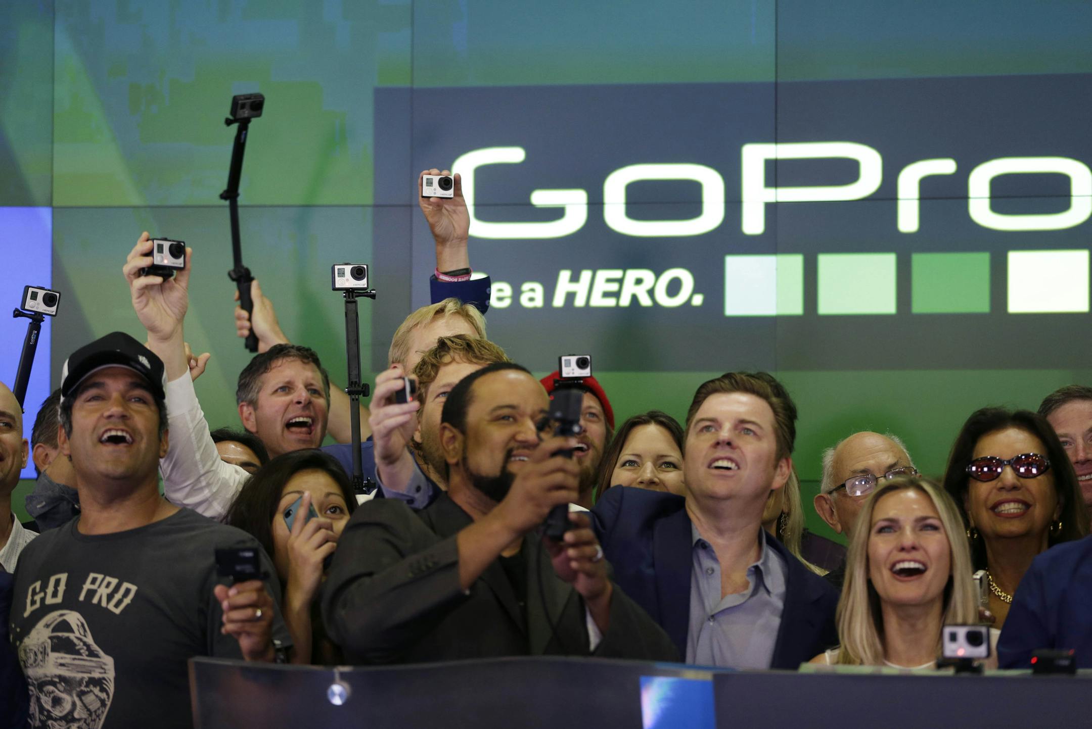 Multiple GoPro cameras were filming the GoPro IPO at the Nasdaq MarketSite in New York, Thursday, June 26, 2014. GoPro has climbed mountaintops and dived to ocean bottoms. Now it's headed somewhere only slightly tamer: Wall Street. The maker of wearable sports cameras, loved by mountain climbers, divers, surfers and other extreme sports fans, said late Wednesday it sold 17.8 million shares at $24 each in its initial public offering of stock. (AP Photo/Seth Wenig)