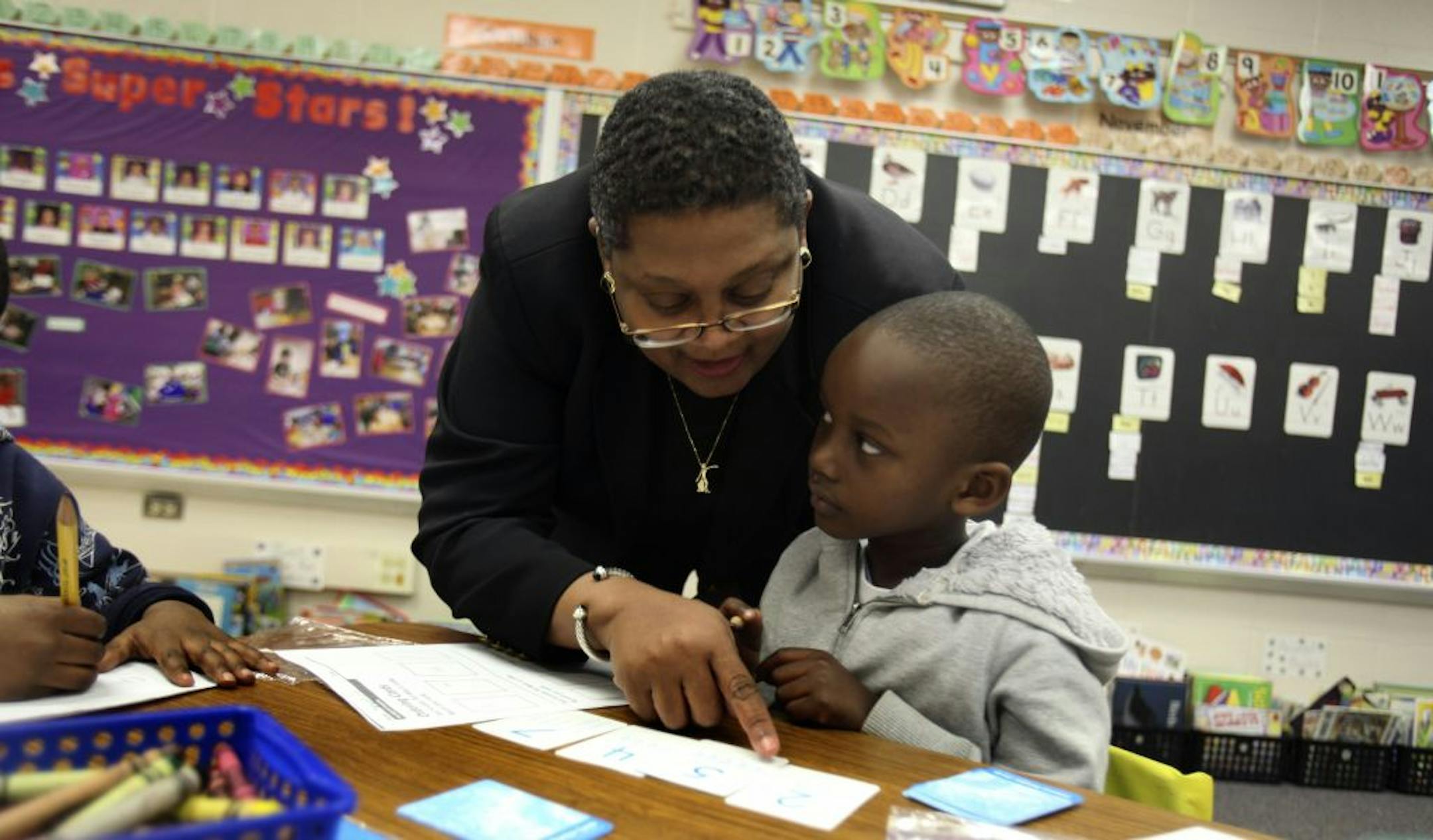 Superintendent Bernadeia Johnson helped kindergartner Jeremie Niyonkuru put his numbered cards in order during her visit to Lyndale School Thursday, December 1, 2011.