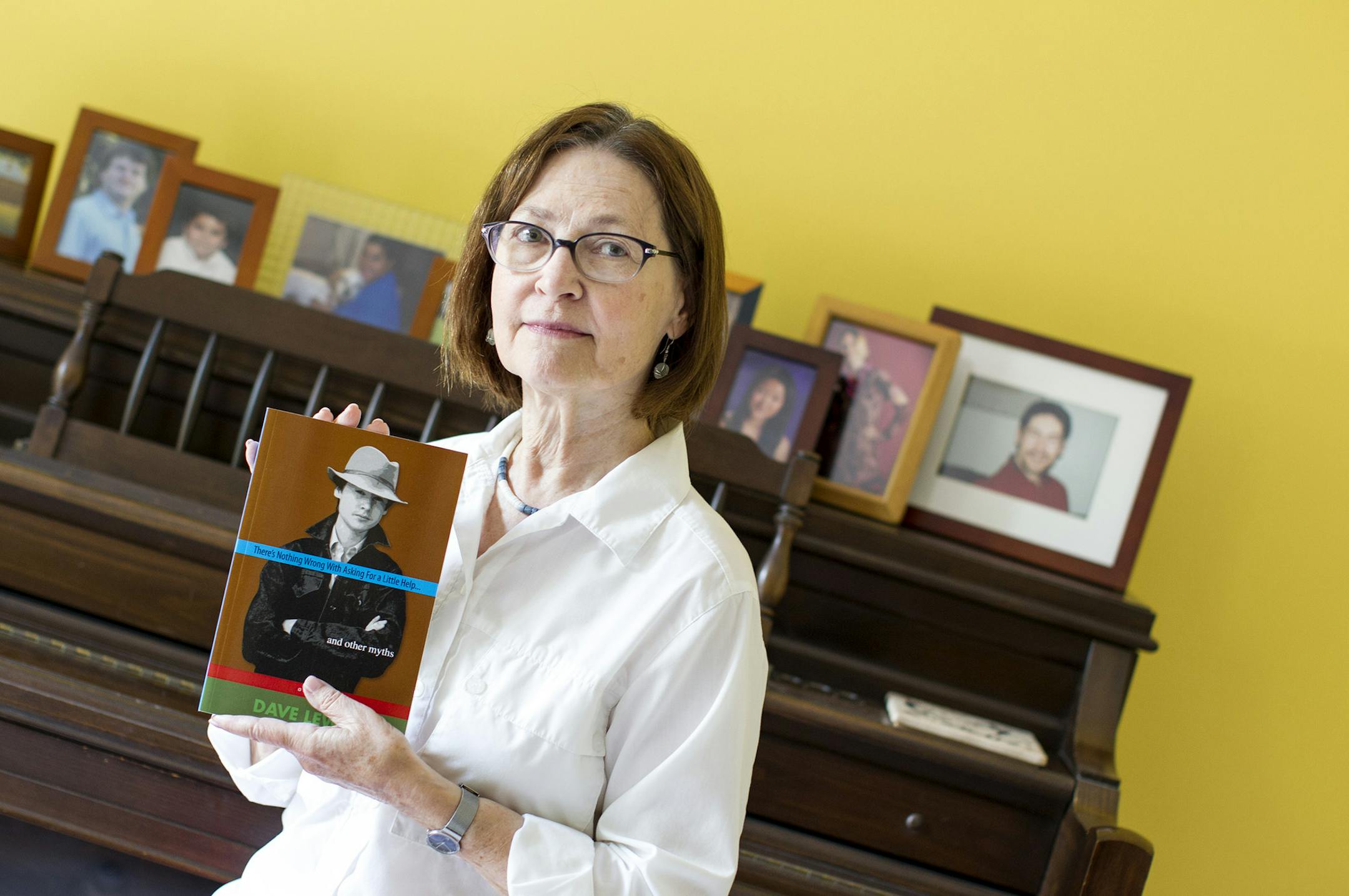 Lyn Culbert holds a copy of the memoir written by her son and published posthumously at her home in St. Louis Park July 16, 2014. Dave Lewis was diagnosed at age 14 with Friedreich's Ataxia, a fatal progressive neuromuscular disease, and for the next 25 years he challenged himself to live life to the fullest. (Courtney Perry/Special to the Star Tribune)