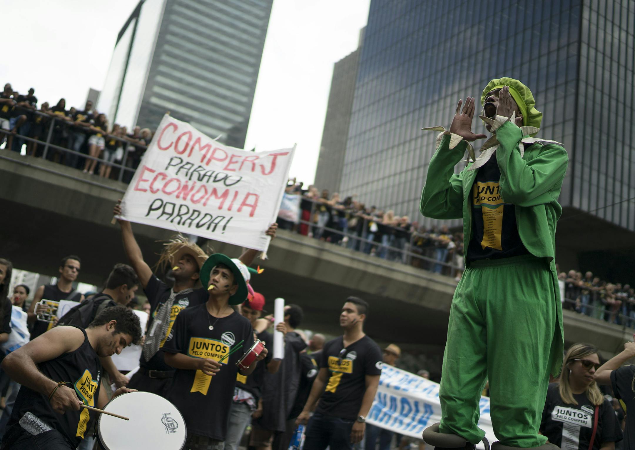 In this Monday, Aug. 24, 2015 photo, a man shouts slogans during a protest against layoffs, in front of Petrobras headquarters in Rio de Janeiro, Brazil. With an economy in recession, along with growing inflation and unemployment, Brazilís top electoral court is investigating if any of the Petrobras kickback money was used to fund president Dilma Rousseff's re-election campaign last year, in which she won a narrow victory. (AP Photo/Leo Correa)