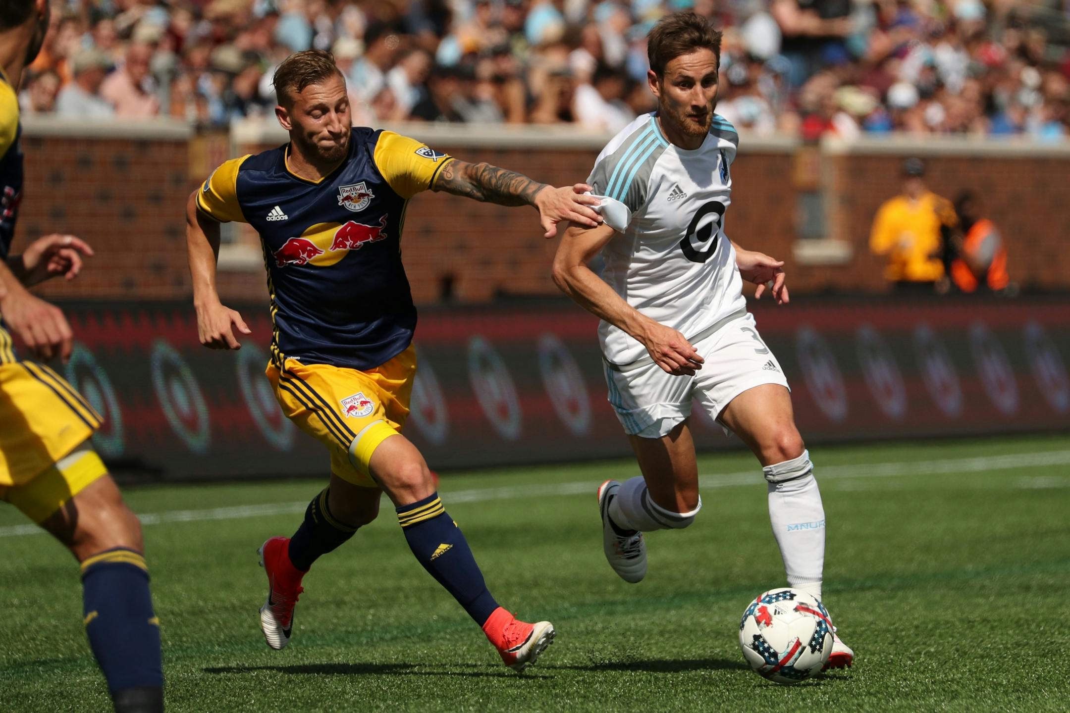New York Red Bulls midfielder Daniel Royer (77) reached out to try and stop Minnesota United midfielder Jerome Thiesson (3) as he dribbled the ball up field in the second half.