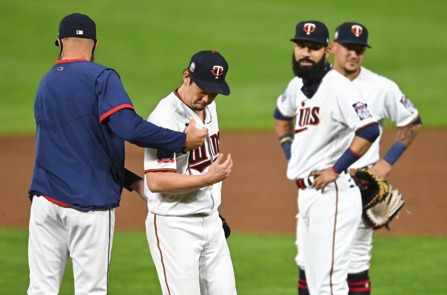 Twins manager Rocco Baldelli took the ball from starting pitcher Kenta Maeda (18) as he walked to the dugout after his no hitter was broken up in the top of the ninth inning.